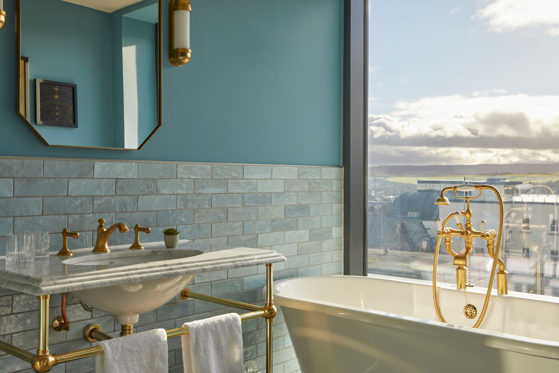 brick and metro wall tiles used in a high rise apartment building with golden brass taps and blue wall tiles
