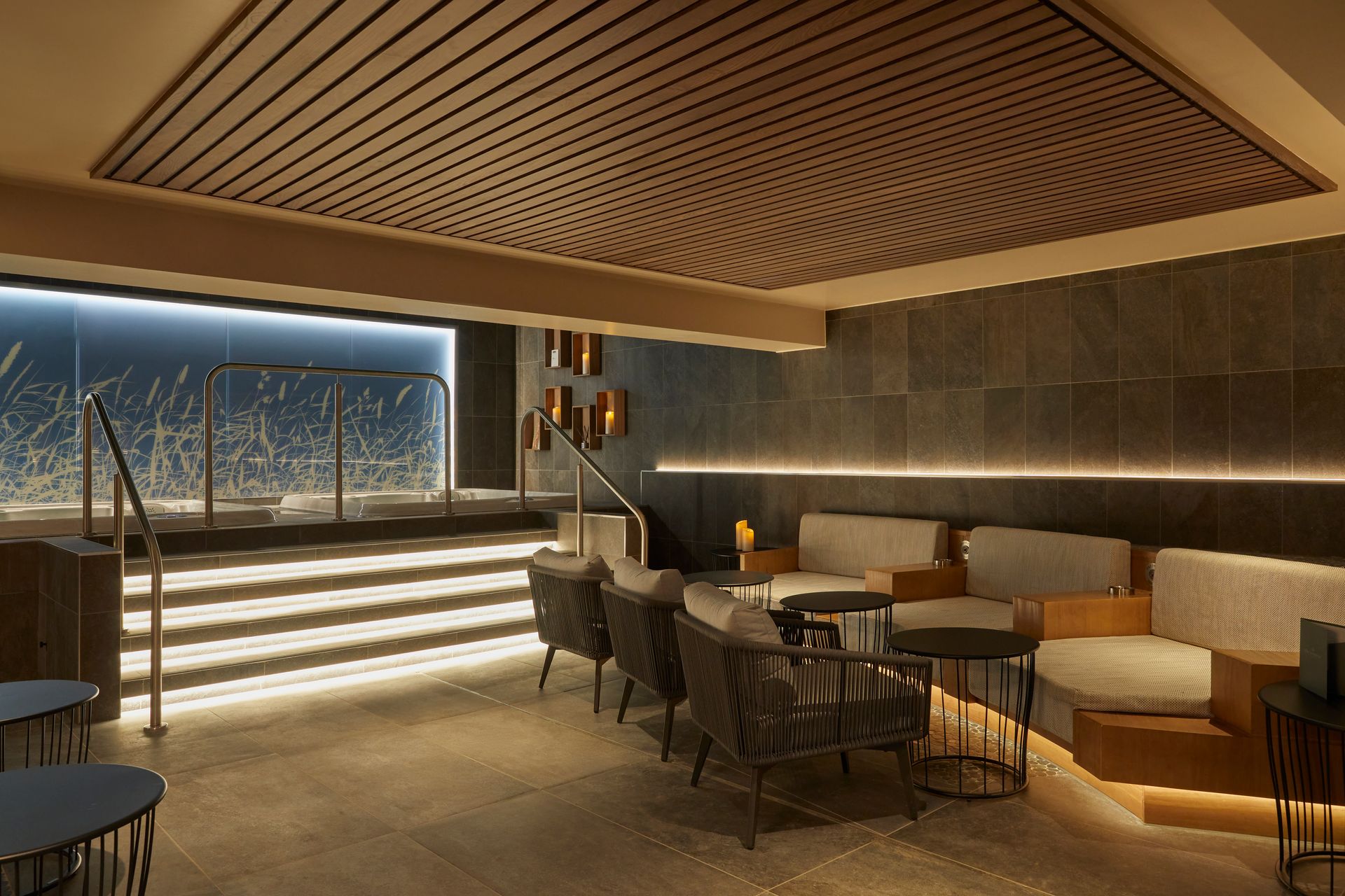 Roomshot of dining area with white chairs and tables and a concrete floor effect