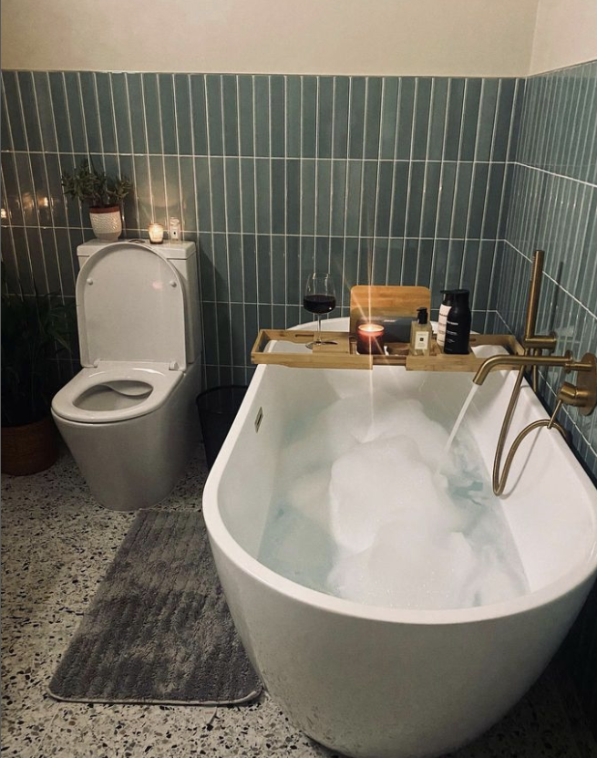 metro pink wall tiles, 250x50mm tonal, navy blue, wall hung mirror and concrete vanity sink, terrazzo floor