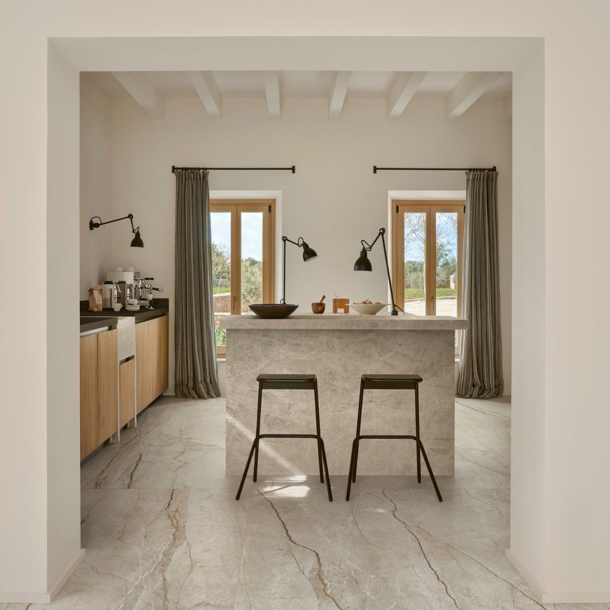 Veina Grey Beige Tile Grey marble tile floor, minimal kitchen with black metal bar stools and marble kitchen island.