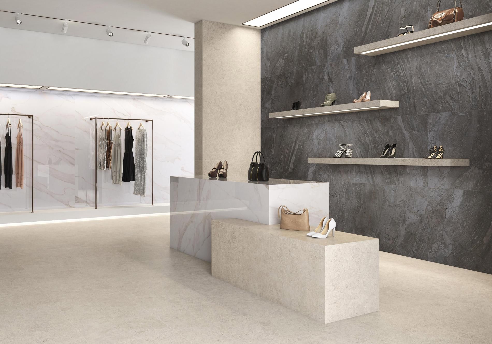 A high-end boutique with sleek, modern decor featuring a combination of black and white stone wall panels. The light beige floor tiles add warmth to the sophisticated design, with shelves displaying luxury handbags and accessories.
