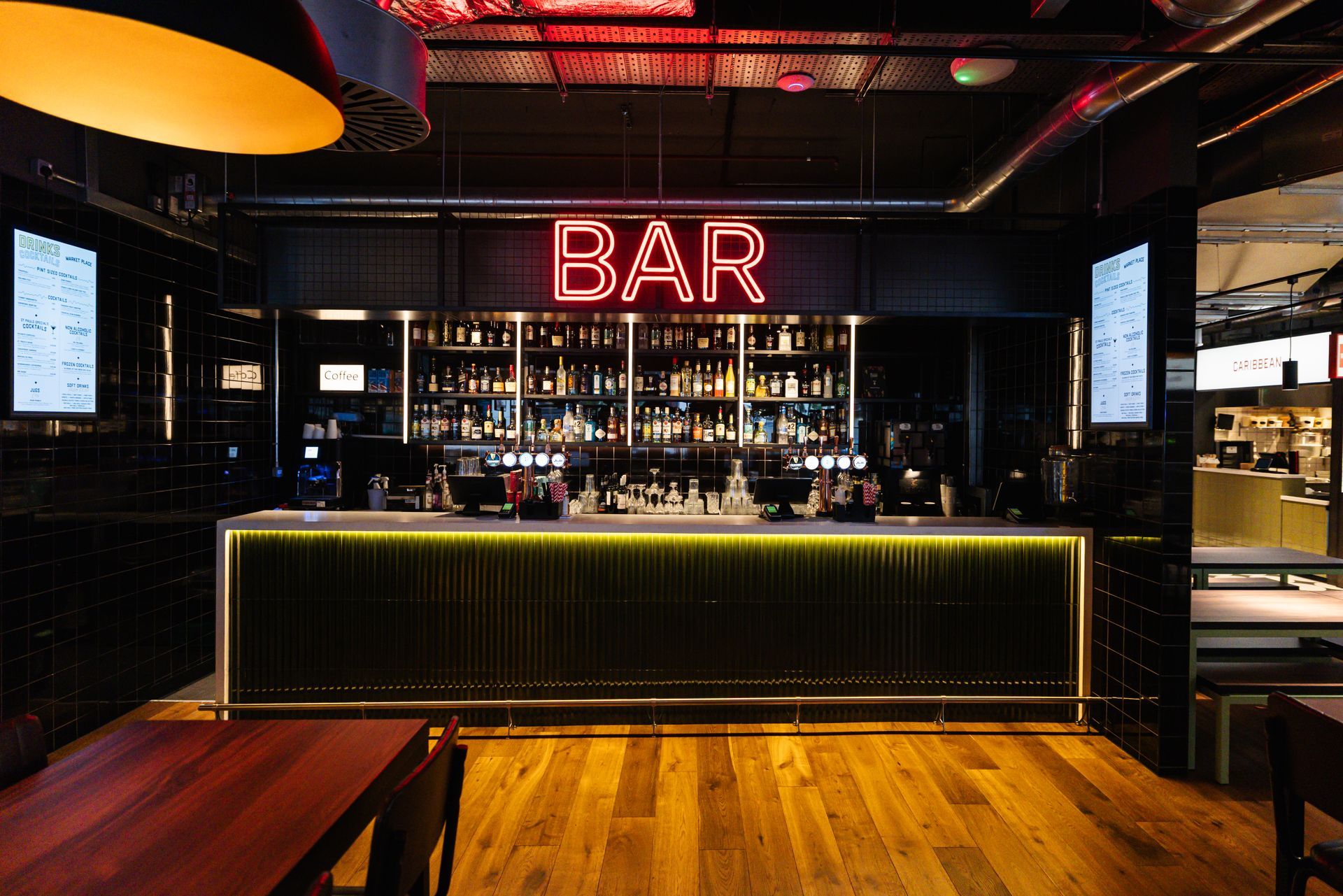 Resturant eating area with tables and chairs and a verde terrazo effect floor tile
