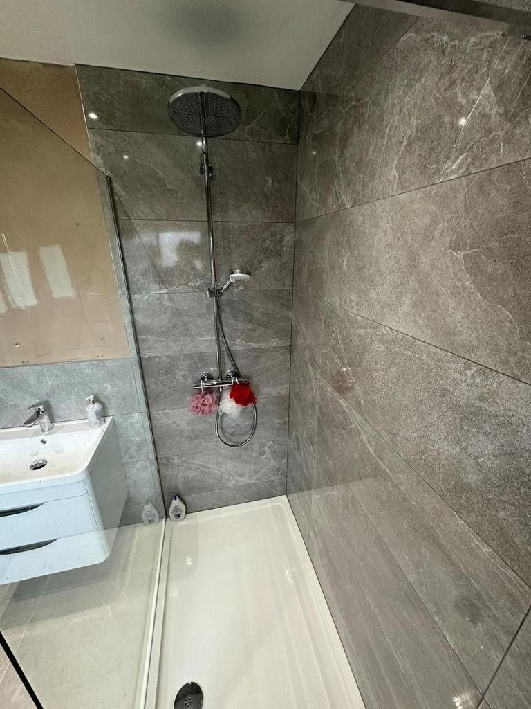 Shower close up with grey tiles