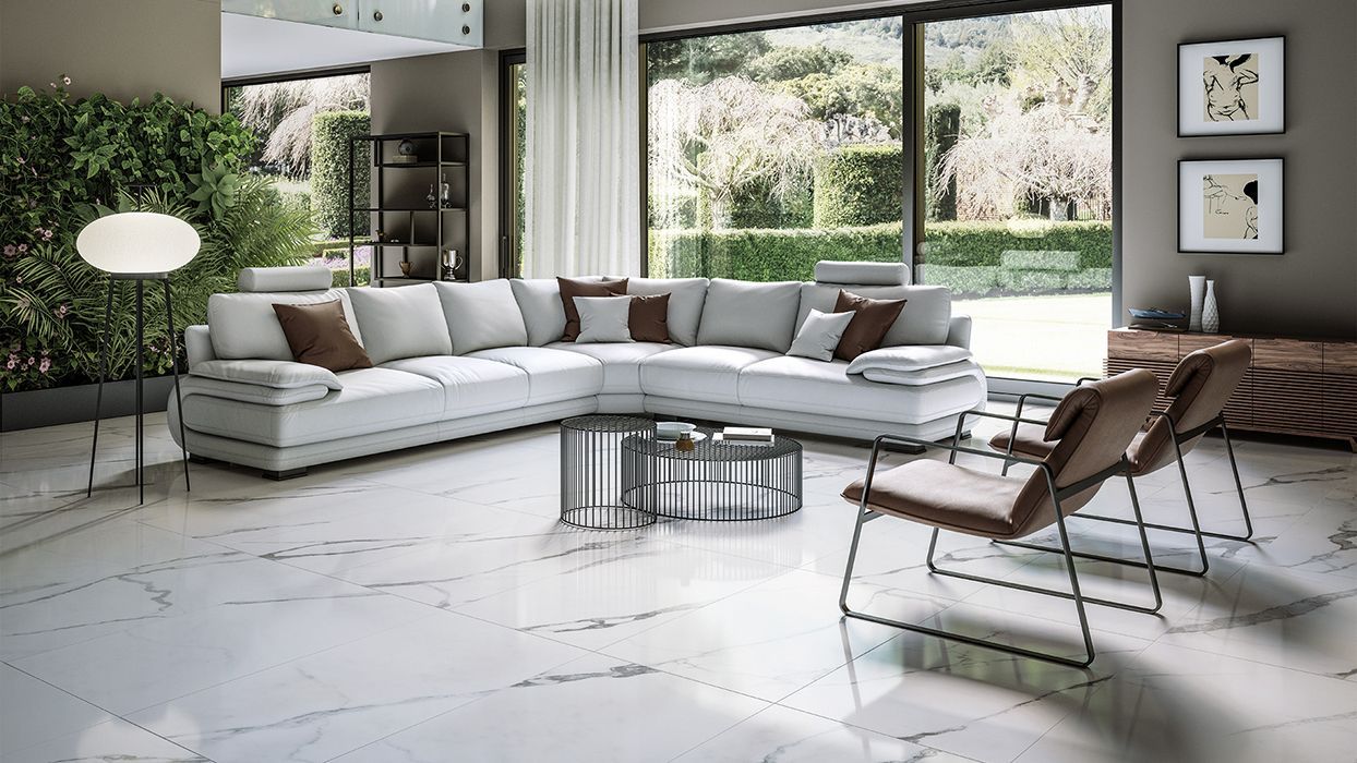 marble floor tiles with a white corner couch and some brown leather chairs