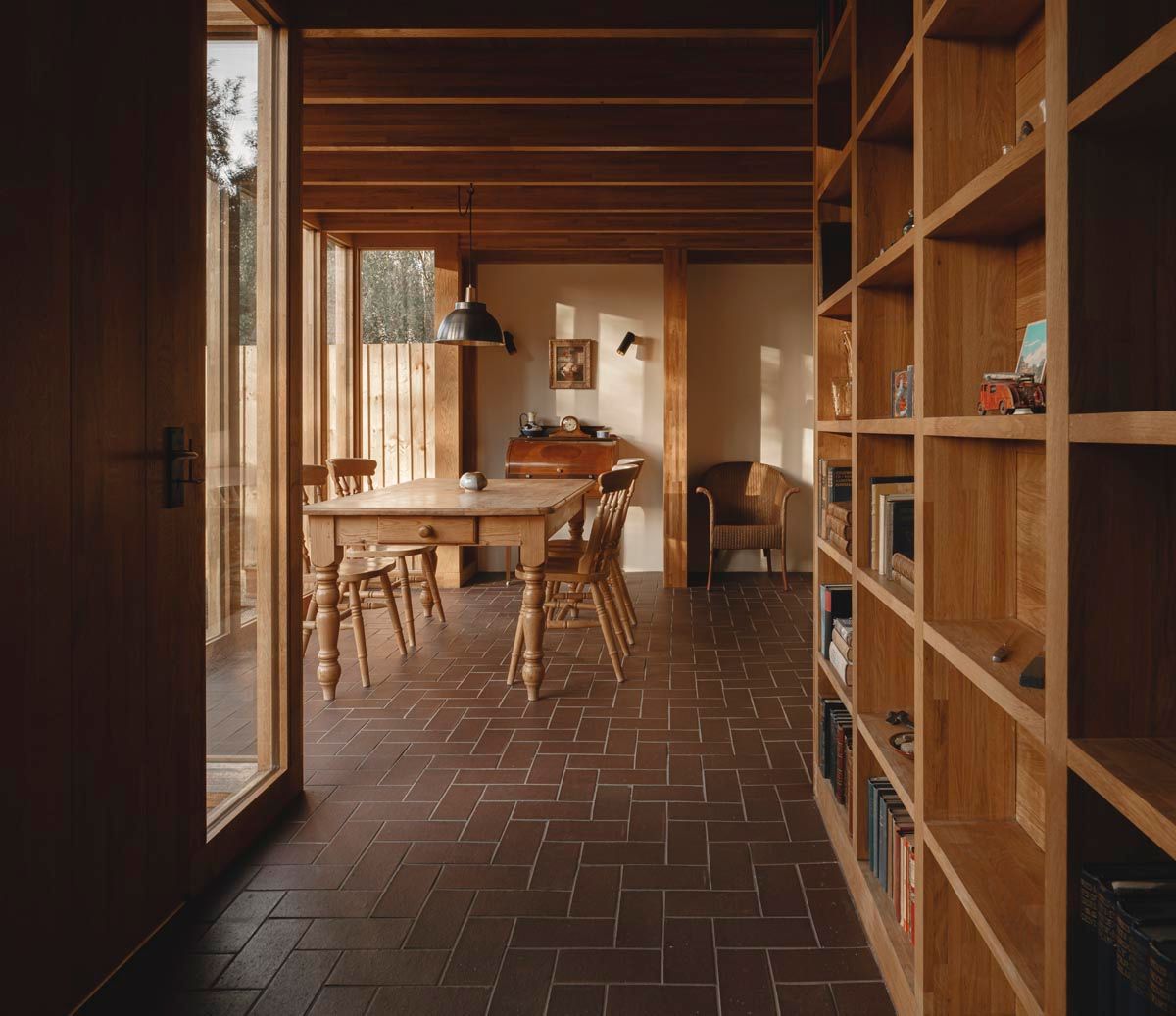 brick flooring in the living room with a bookshelf