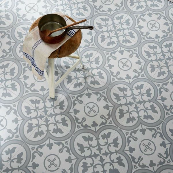 Grey pattern floor tile with a white stool ontop