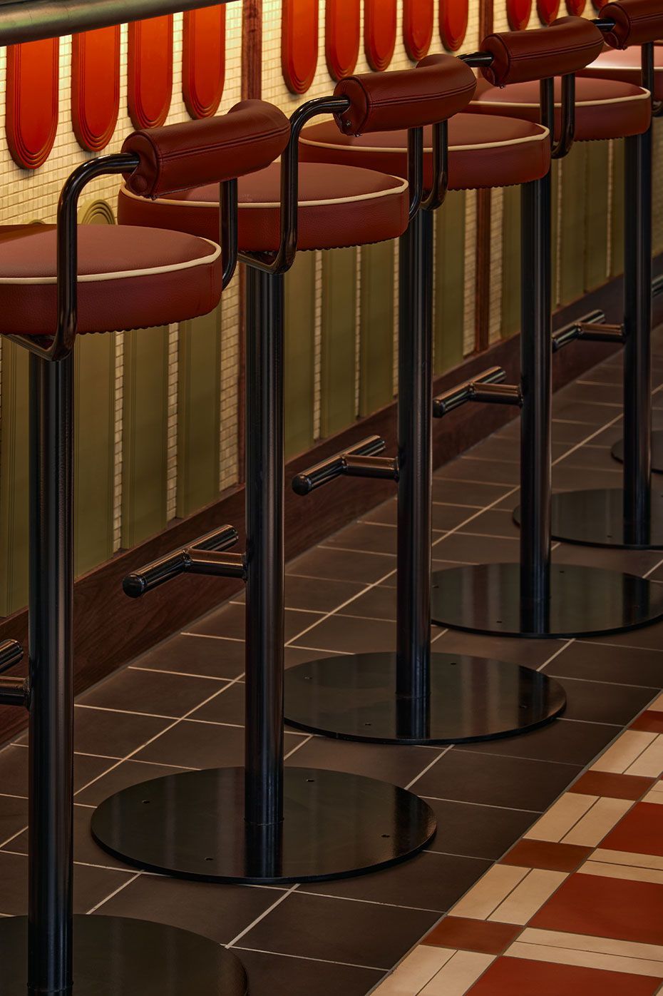 Brown Square tiles on the floor below chairs