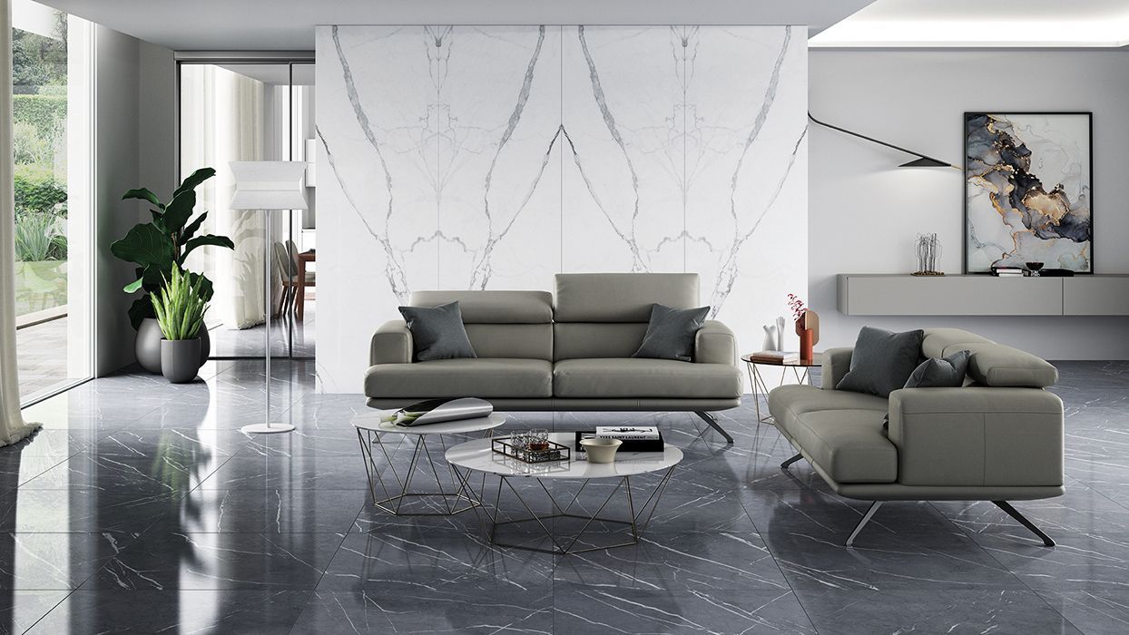 marble tiles , bookmatched tile with a grey couch and black marble floor