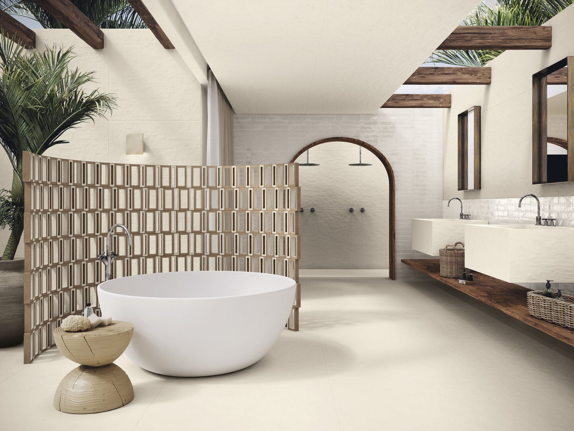 Bathroom with bari white wall tiles and a white bath and 2 sinks