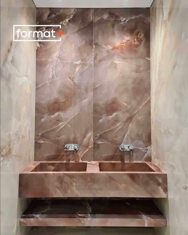 A luxurious bathroom with a bold brown marble sink and wall, featuring a clean rectangular basin and modern fixtures.