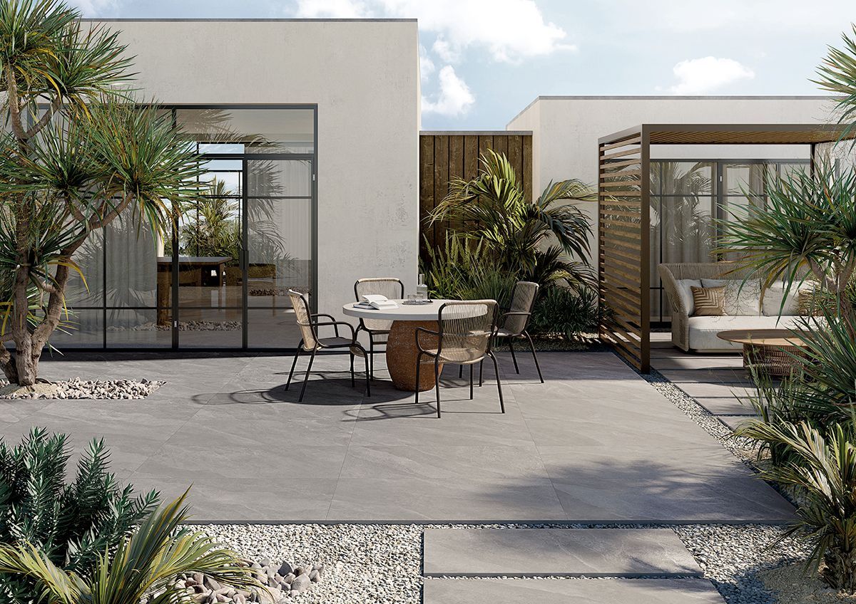 slate effect, outside tiles , garden table with a beige lounge area in a tropical environment, full bodied porcelain