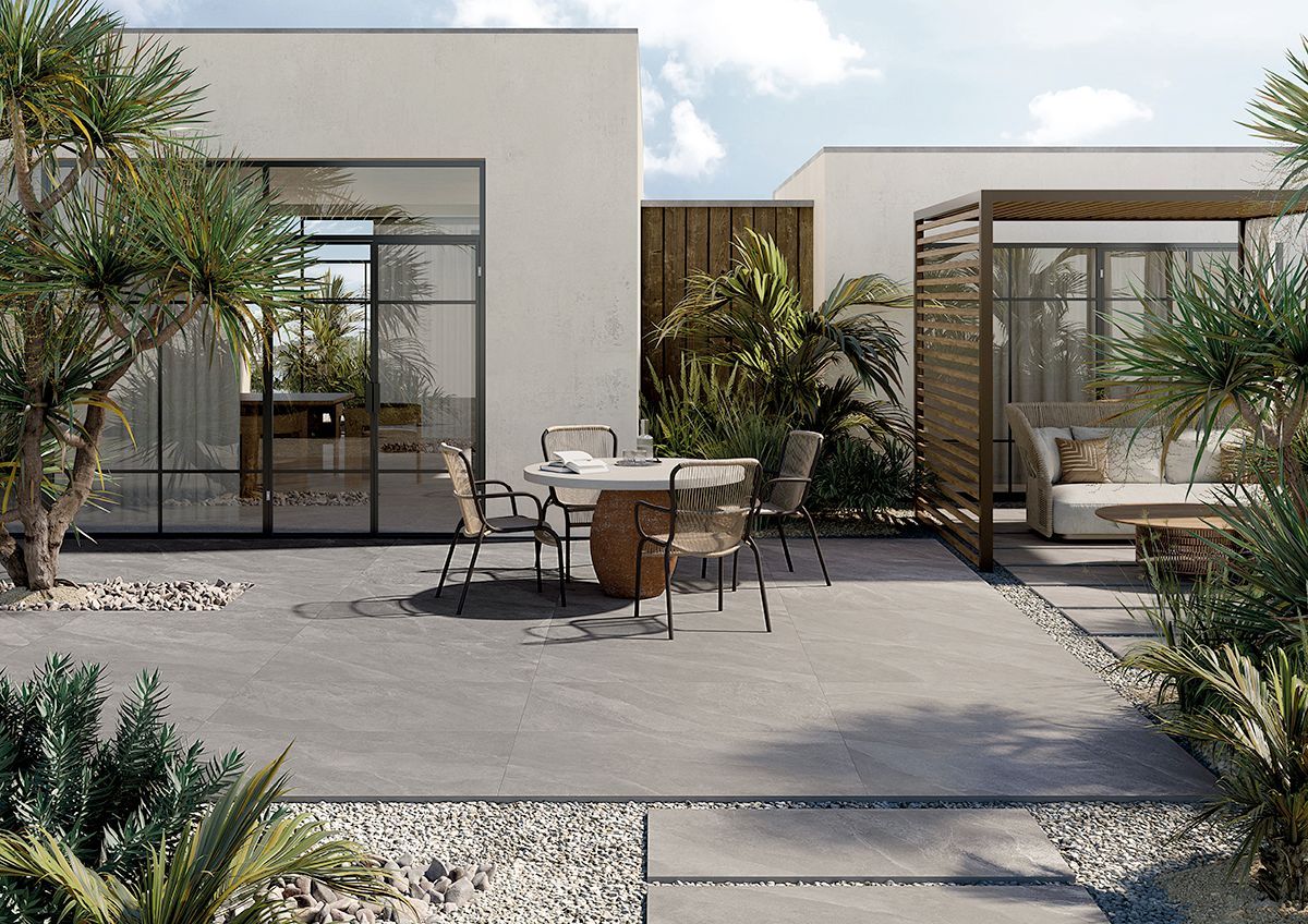 Large format outdoor grey patio tiles with chairs and table ontop of tile