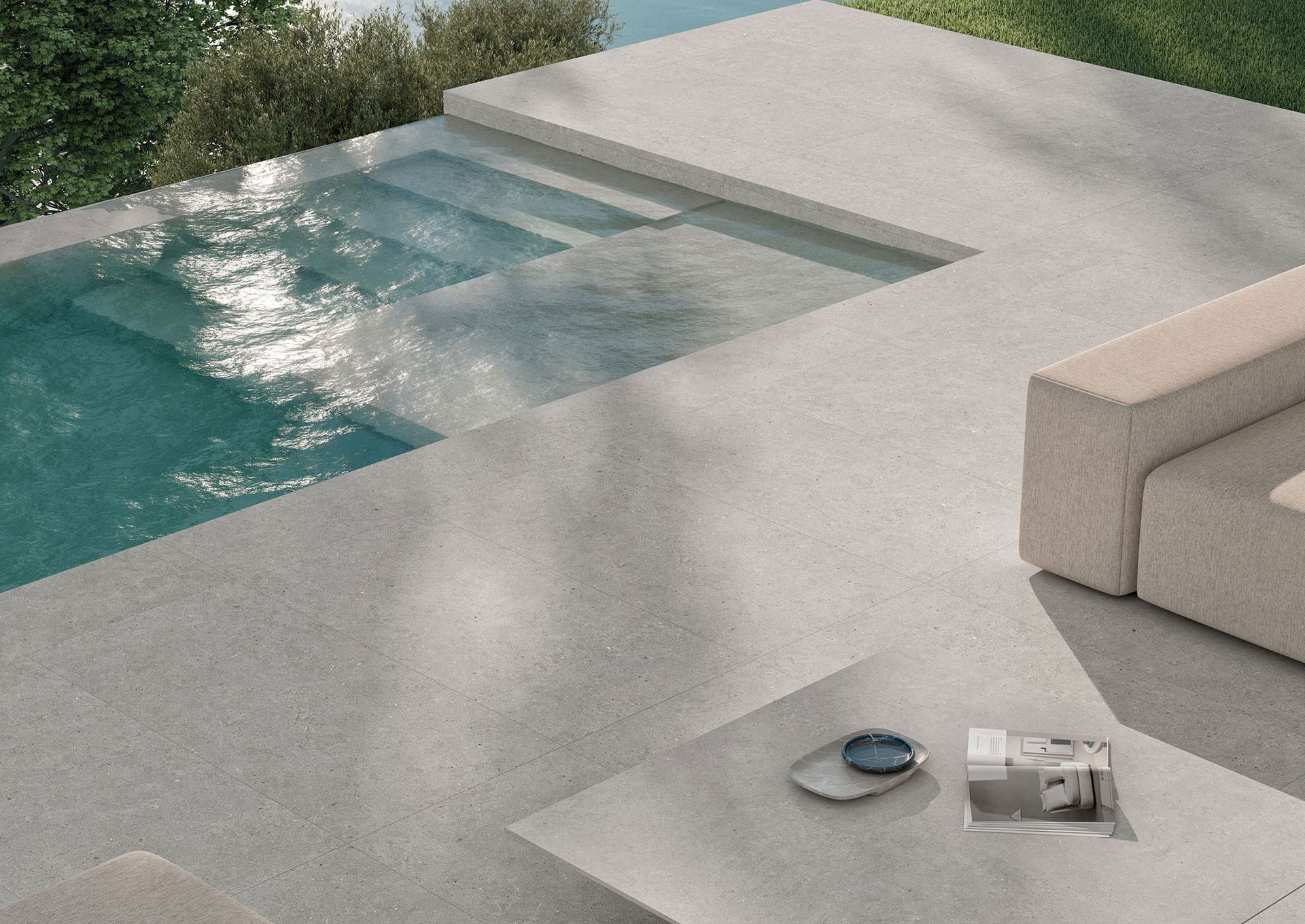 outside pool with concrete effect tiles around it