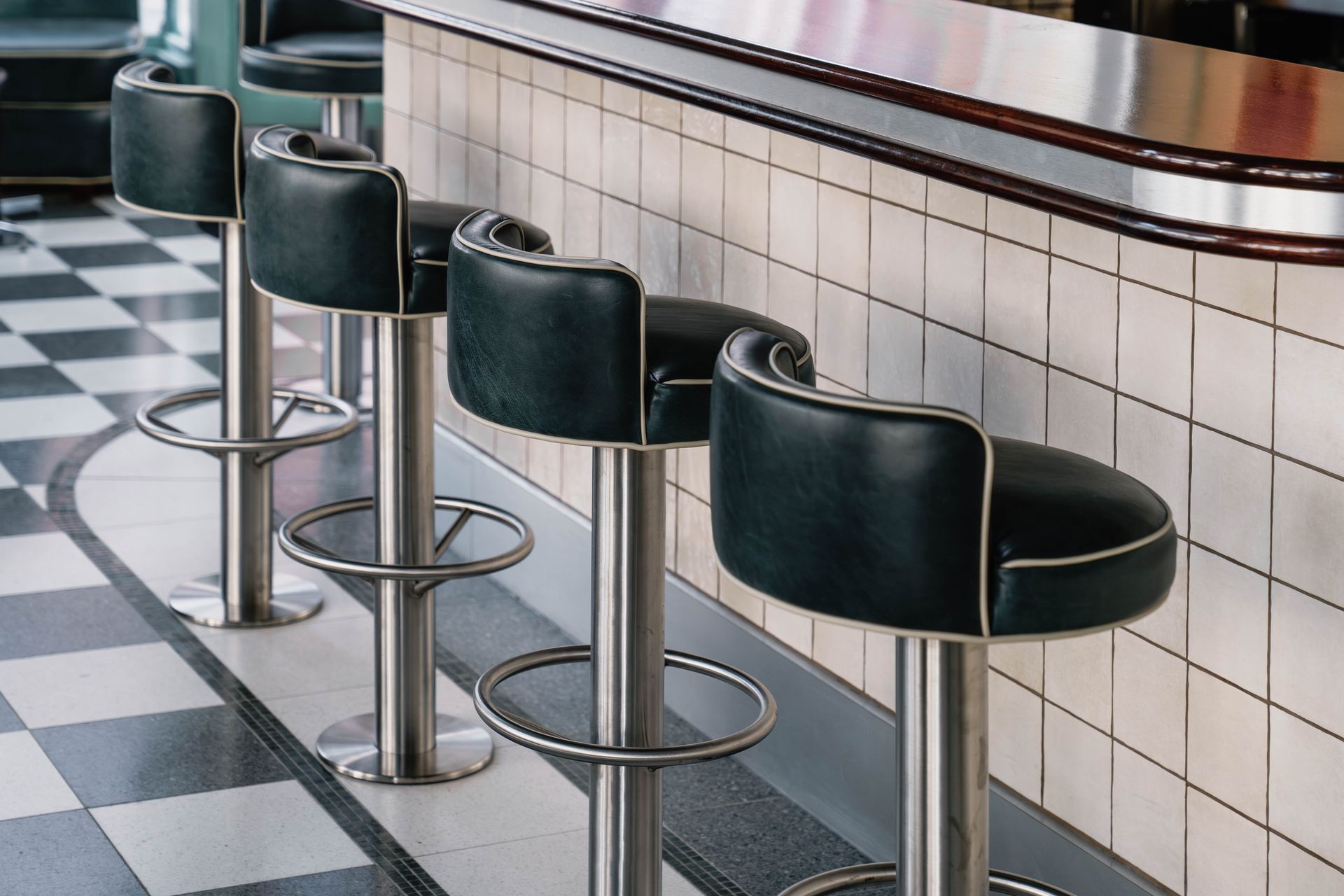Commercial use of our lyon white tiles used to create the bar and chequerboard tile pattern on the floor