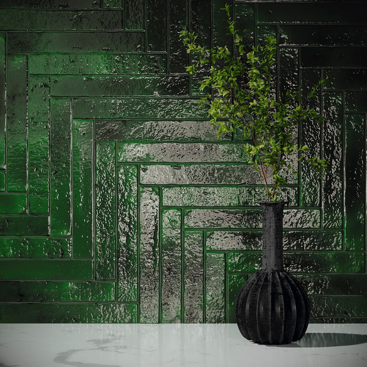 Elegant wall featuring glossy emerald green distressed brick-effect tiles arranged in a geometric pattern, complemented by a sleek black vase with greenery, creating a striking and modern interior design