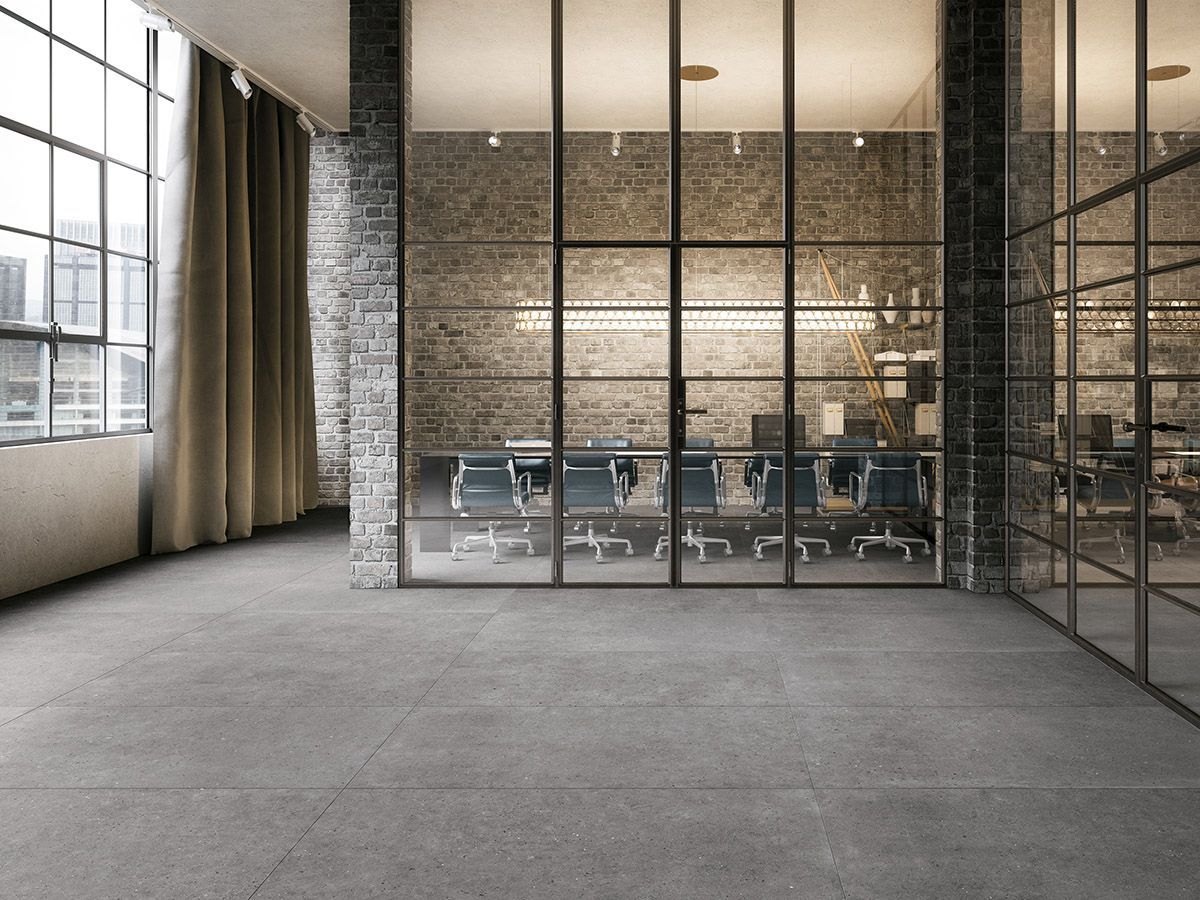 Gris floor tile in office space with big glass panes