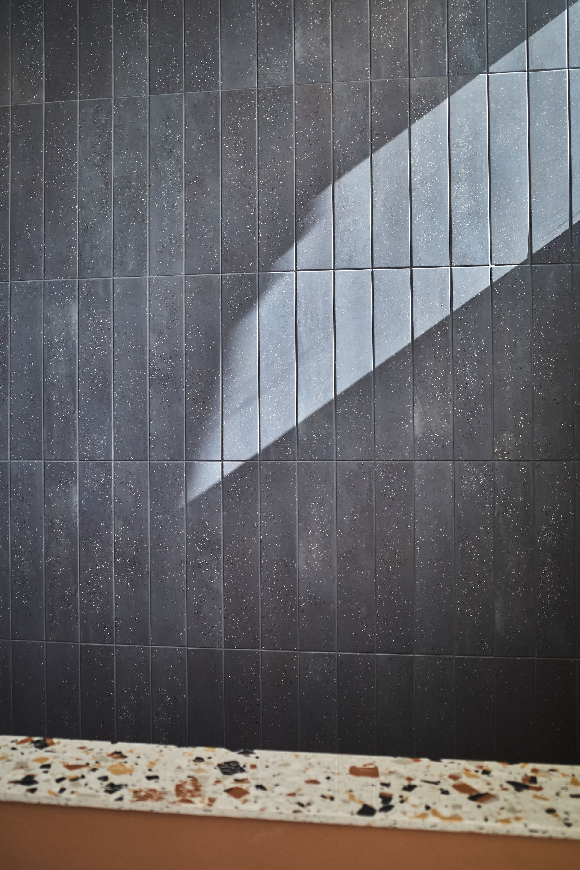 Black gloss wall tiles used for bocca bocca