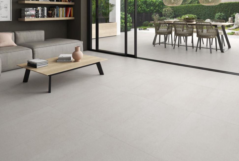 concrete floor tiles , used in a living room design with a wood coffee table