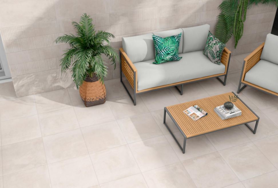 Concrete Floor Tiles in a patio setting with a two seater couch with green cushions