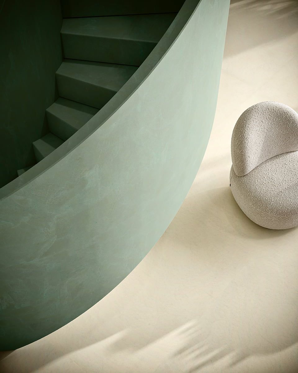 Green stairs with white chair next to it