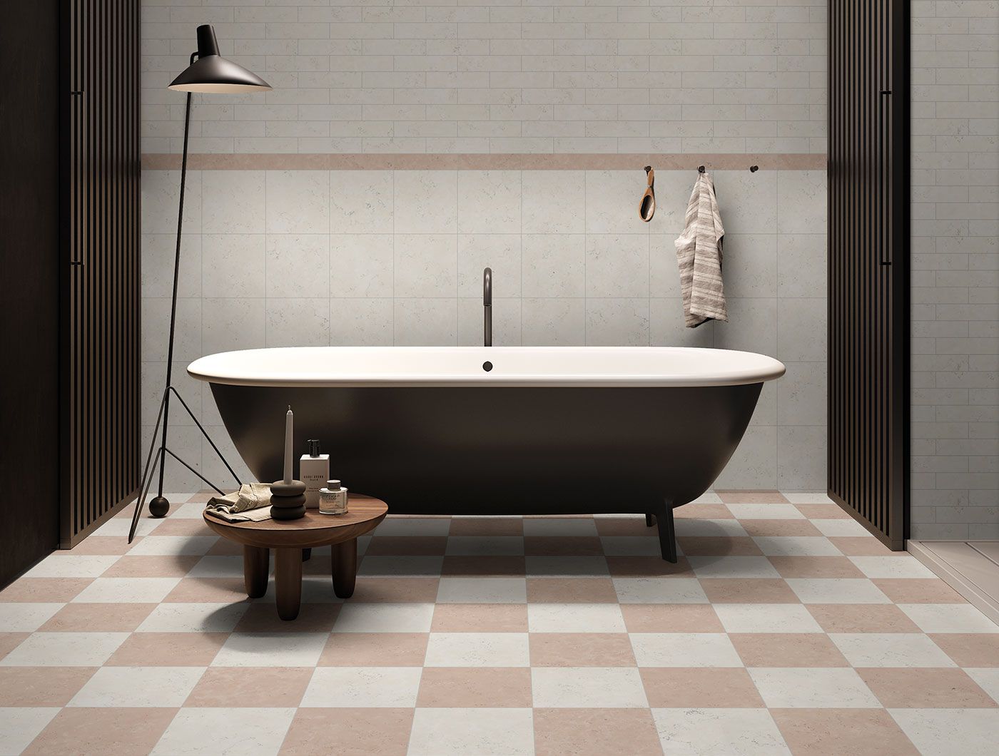 Cream and rojo marble effect chequer bathroom floor with freestanding roll top black bathtub.