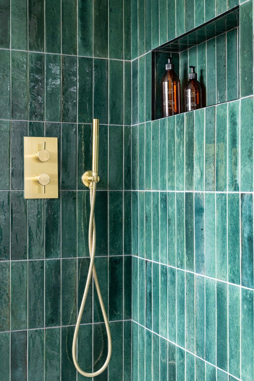 Salerno Verde Tiles with a golden shower accessories