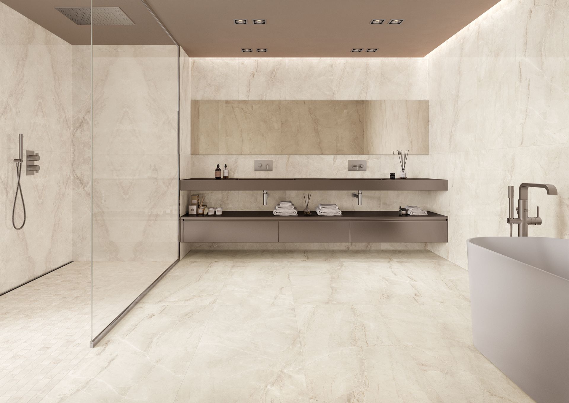 A luxurious bathroom featuring large beige marble-effect tiles covering the walls and floor. The space includes a large walk-in shower with glass partitions, a sleek vanity, and modern fixtures, creating a tranquil and refined environment.