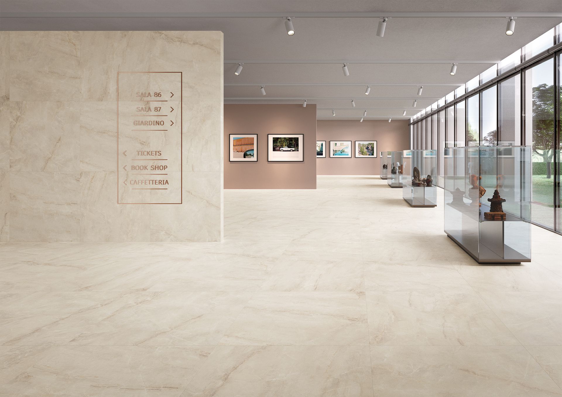 An open gallery space with soft beige marble-effect floor tiles. The room has modern, minimalistic decor with glass display cases and beige walls, creating a clean, spacious feel.