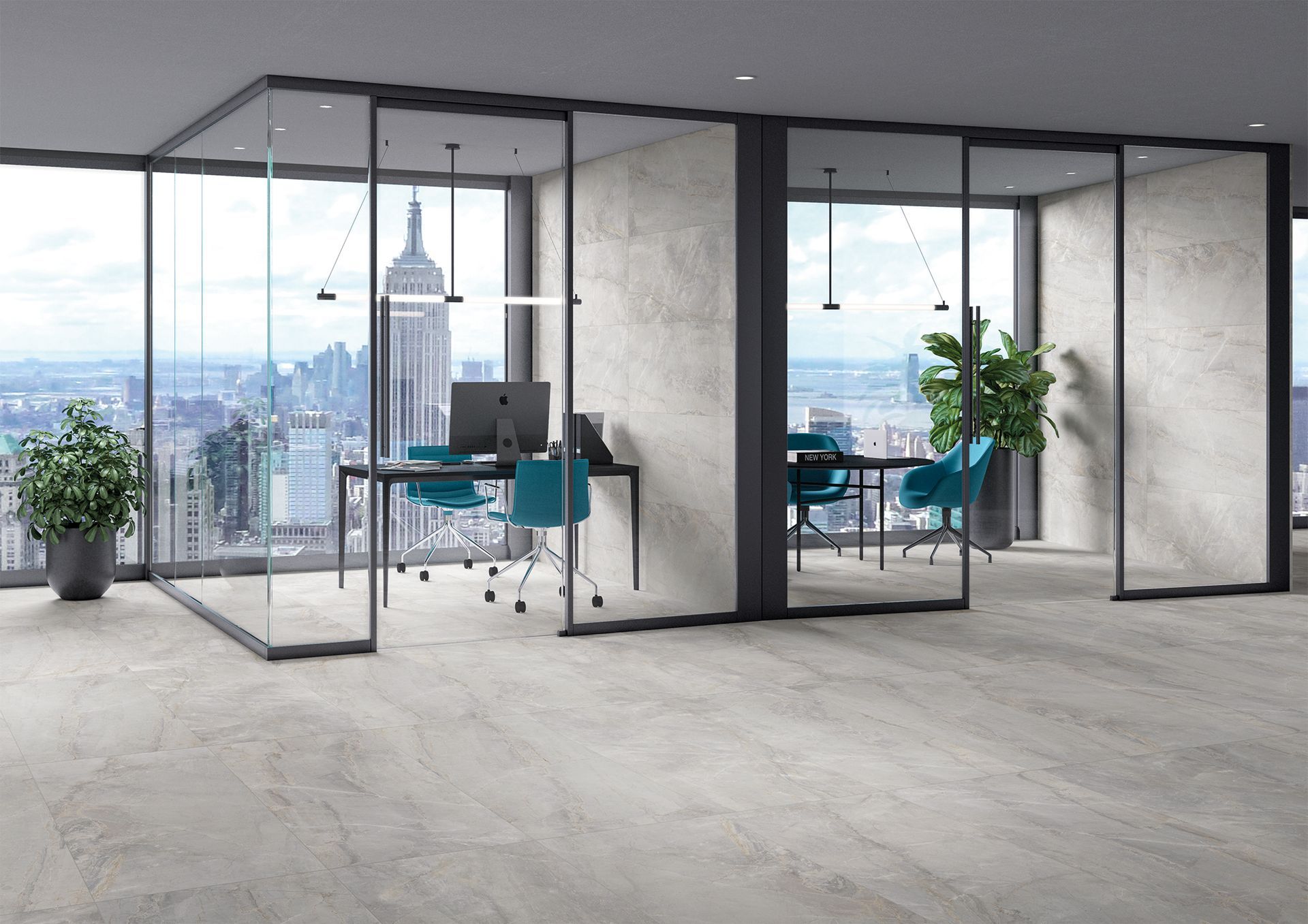 A stylish office space featuring soft gray stone-effect floor tiles, glass partition walls, and a view of the New York City skyline. The modern office furniture and plants add to the sleek, professional environment.