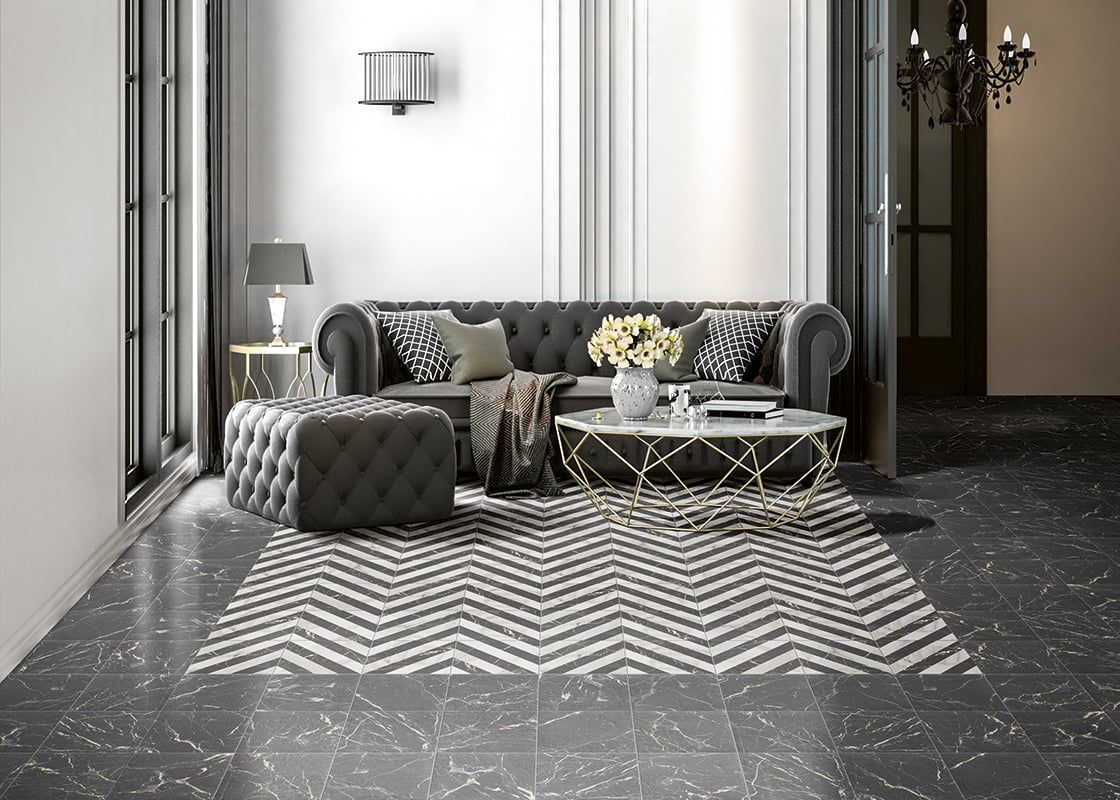 Terrazzo effect floor tiles used in a modern black living room with chevron pattern floor tiles