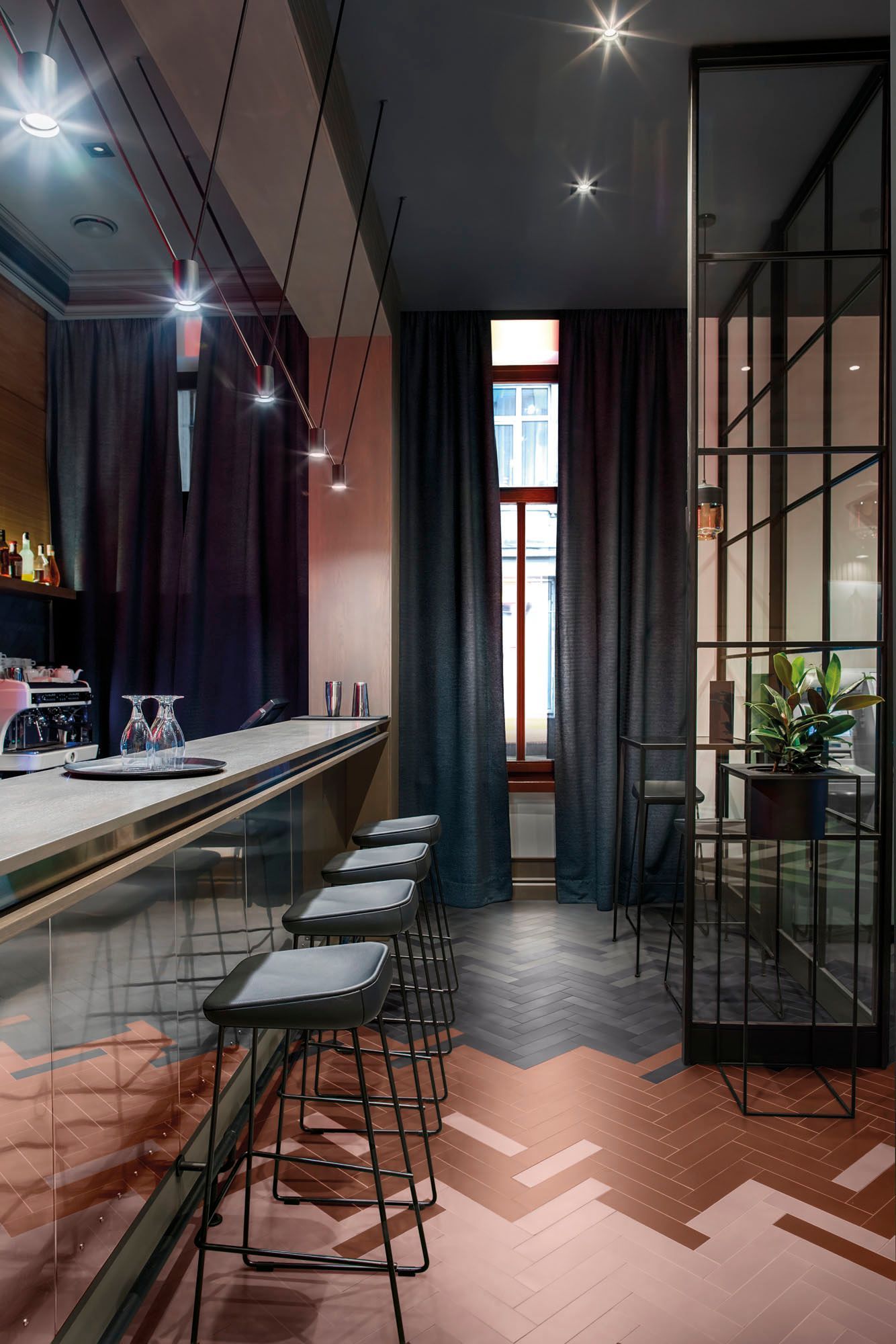 Bricolo tiles used in a bar with stools and glasses on the table