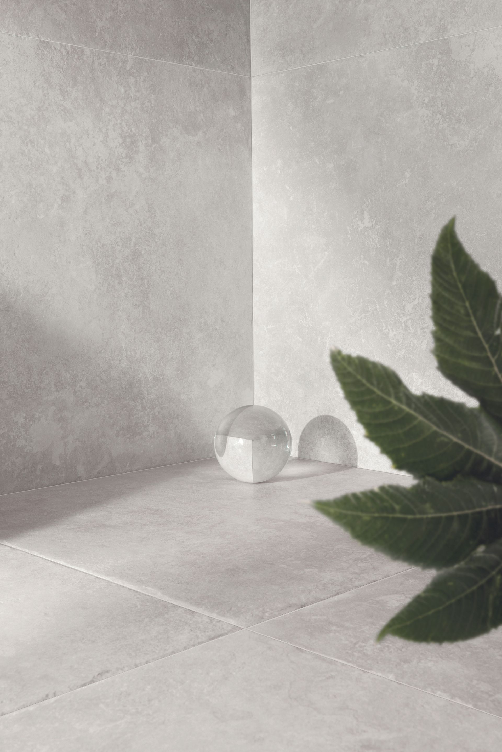 limestone effect tiles with a transparent ball and a plant