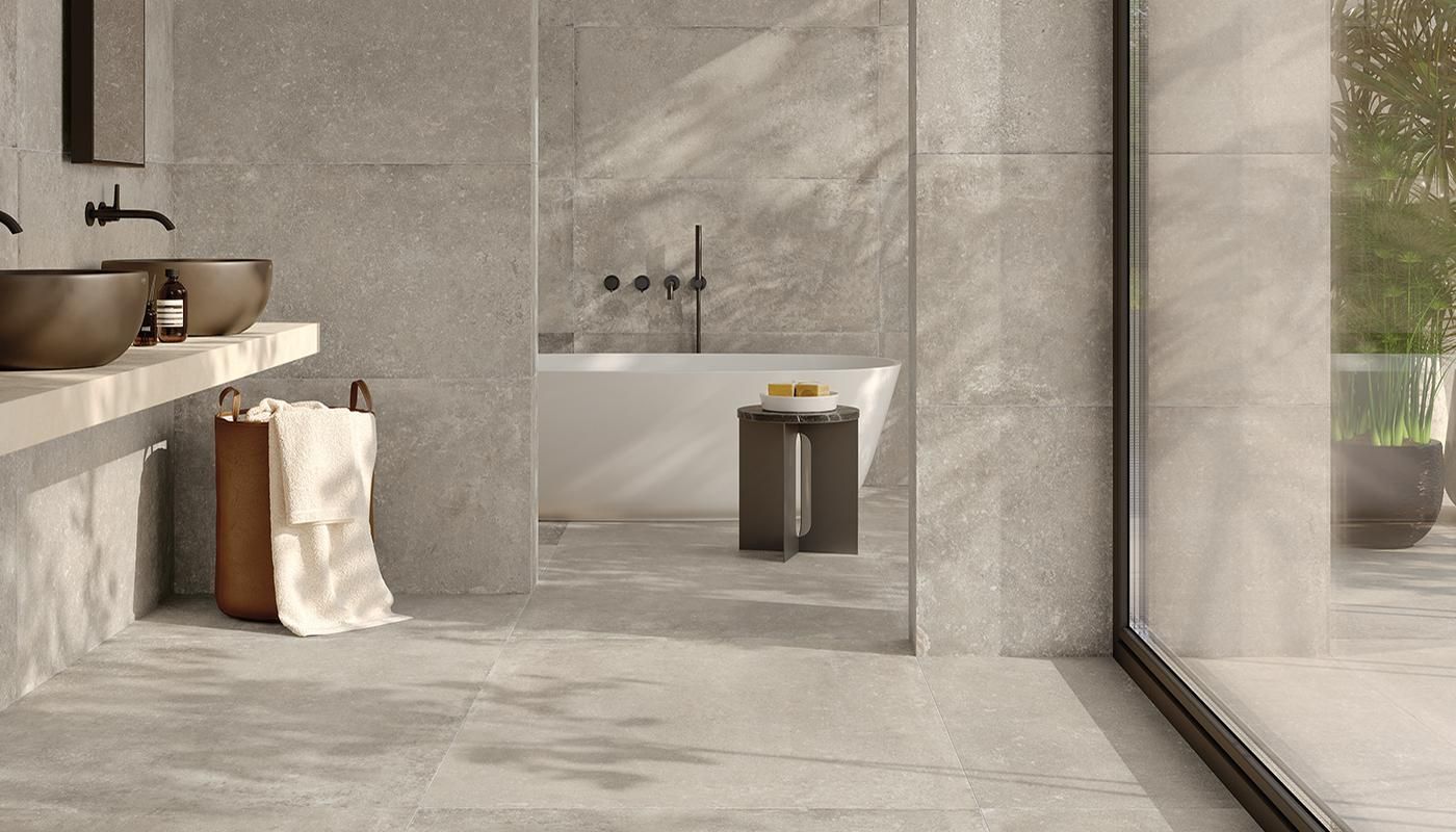 Prato grey tile used on the floors and walls of this modern on suite