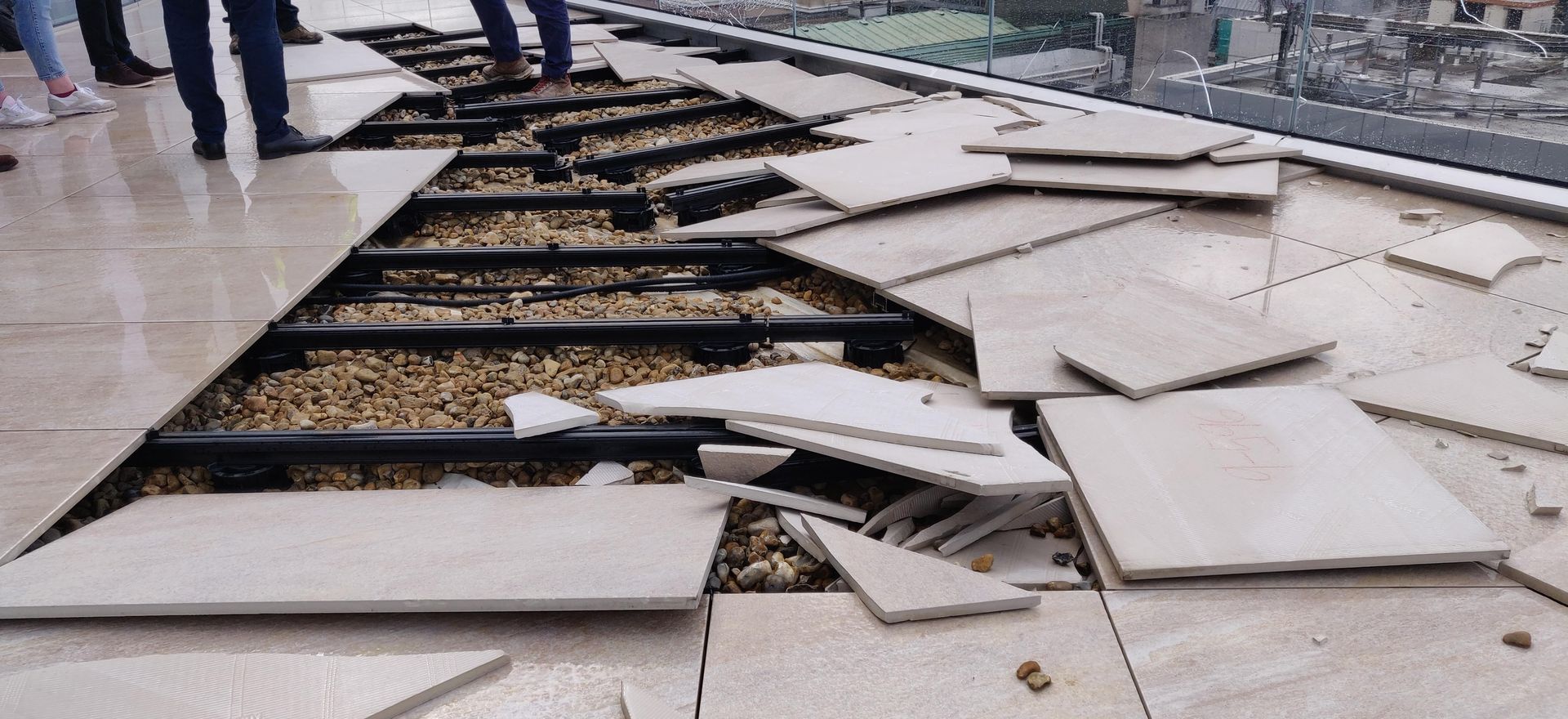 Windproof outfoor flooring shown being ripped up and replaced