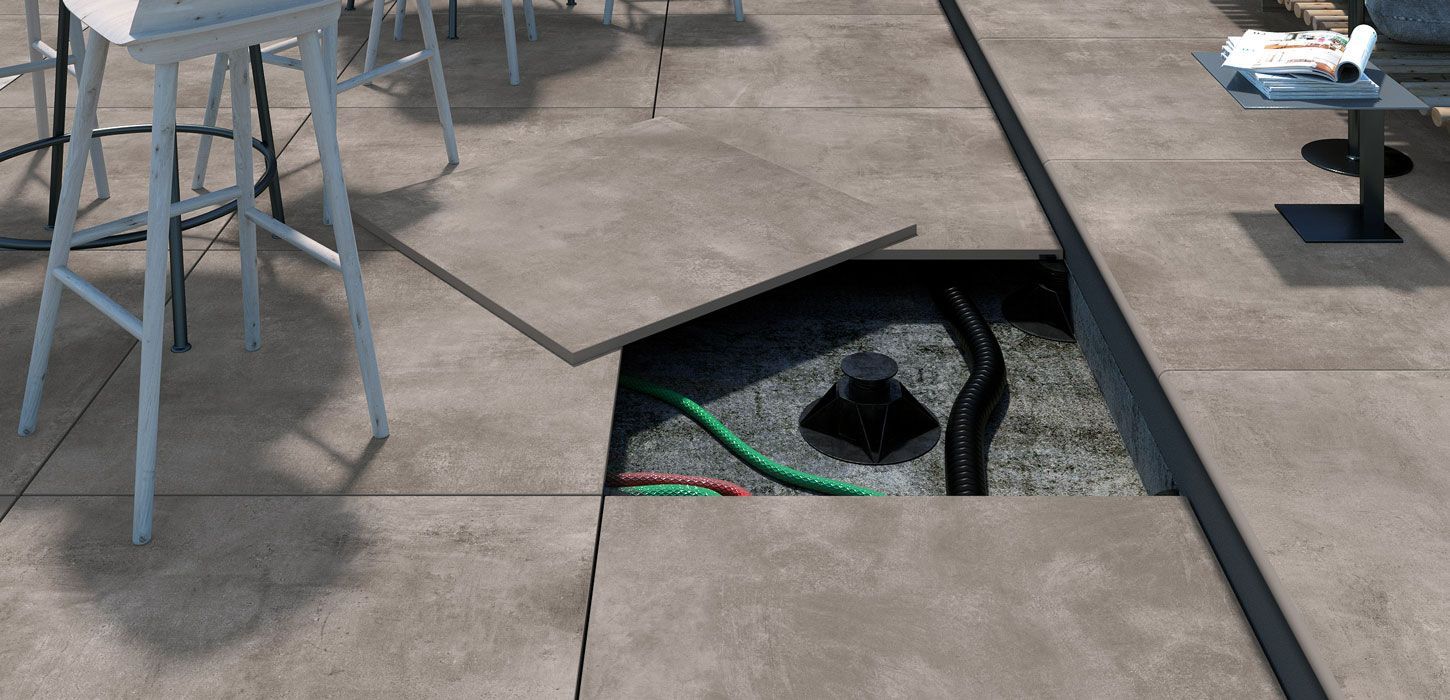 a demonstration of using pedestals on outdoor tiles