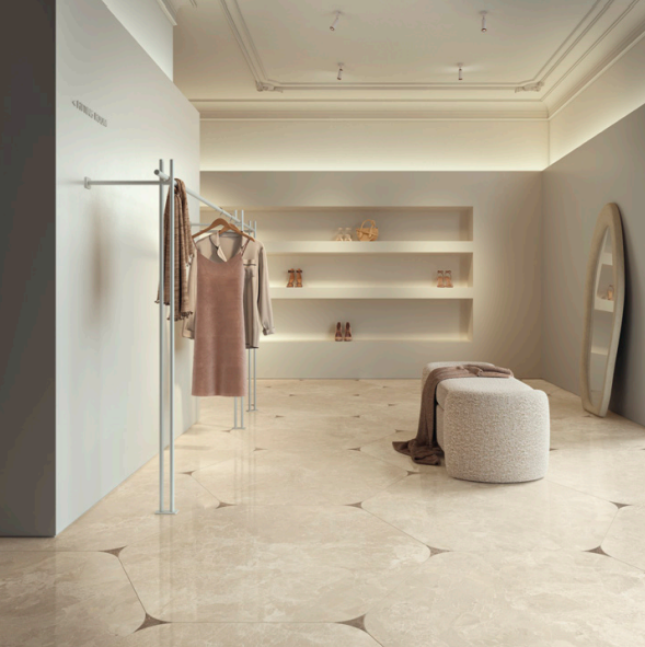 Limestone effect cream hexagonal tile floor with inserts, store floor space, clothing rack and soft seating bench