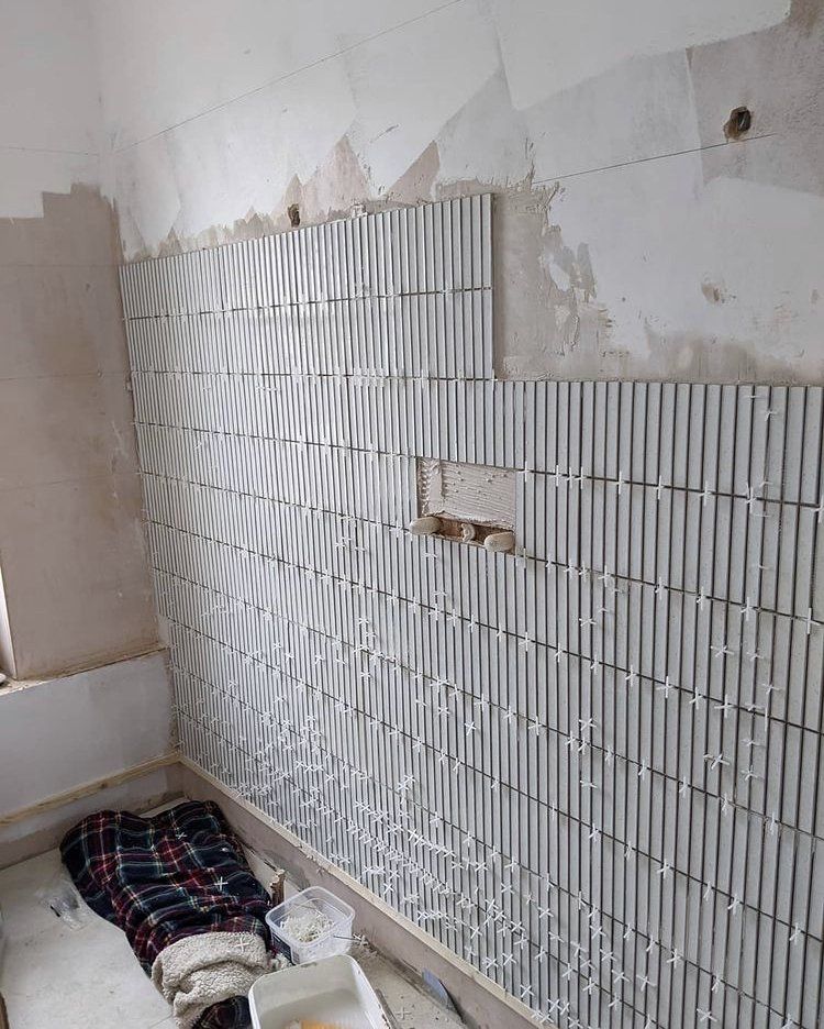 Kit Kat white Mosaic tiles being installed during bathroom renovation