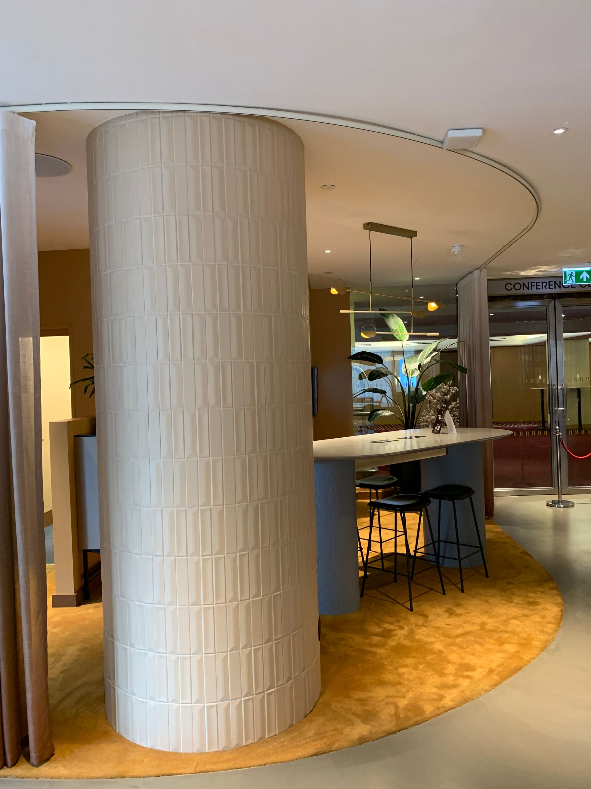 Pillar in london office space tiled with our lustra tiles