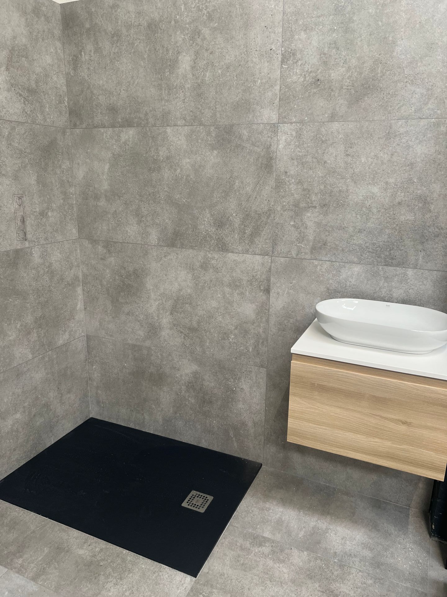 close up from our corby showroom featuring grey wall tiles
