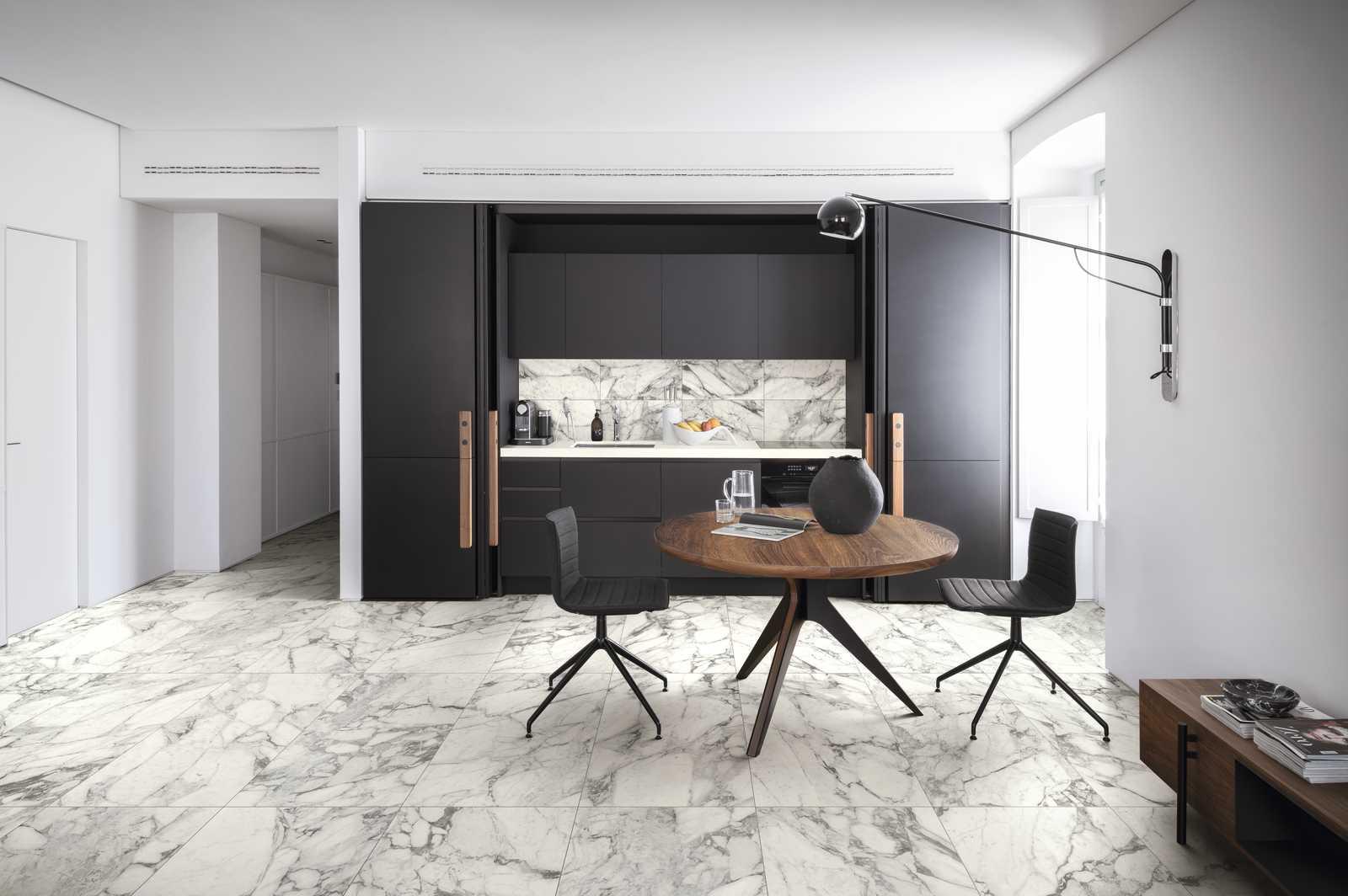 White marble floor tile used in kitchen  wood table and black chairs
