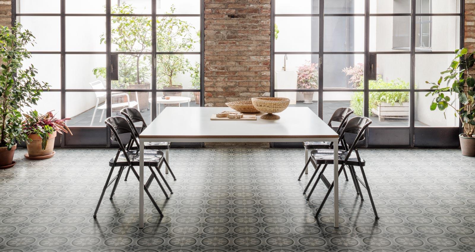 geometric pattern floor tiles, kitchen table, black accent windows, dining area