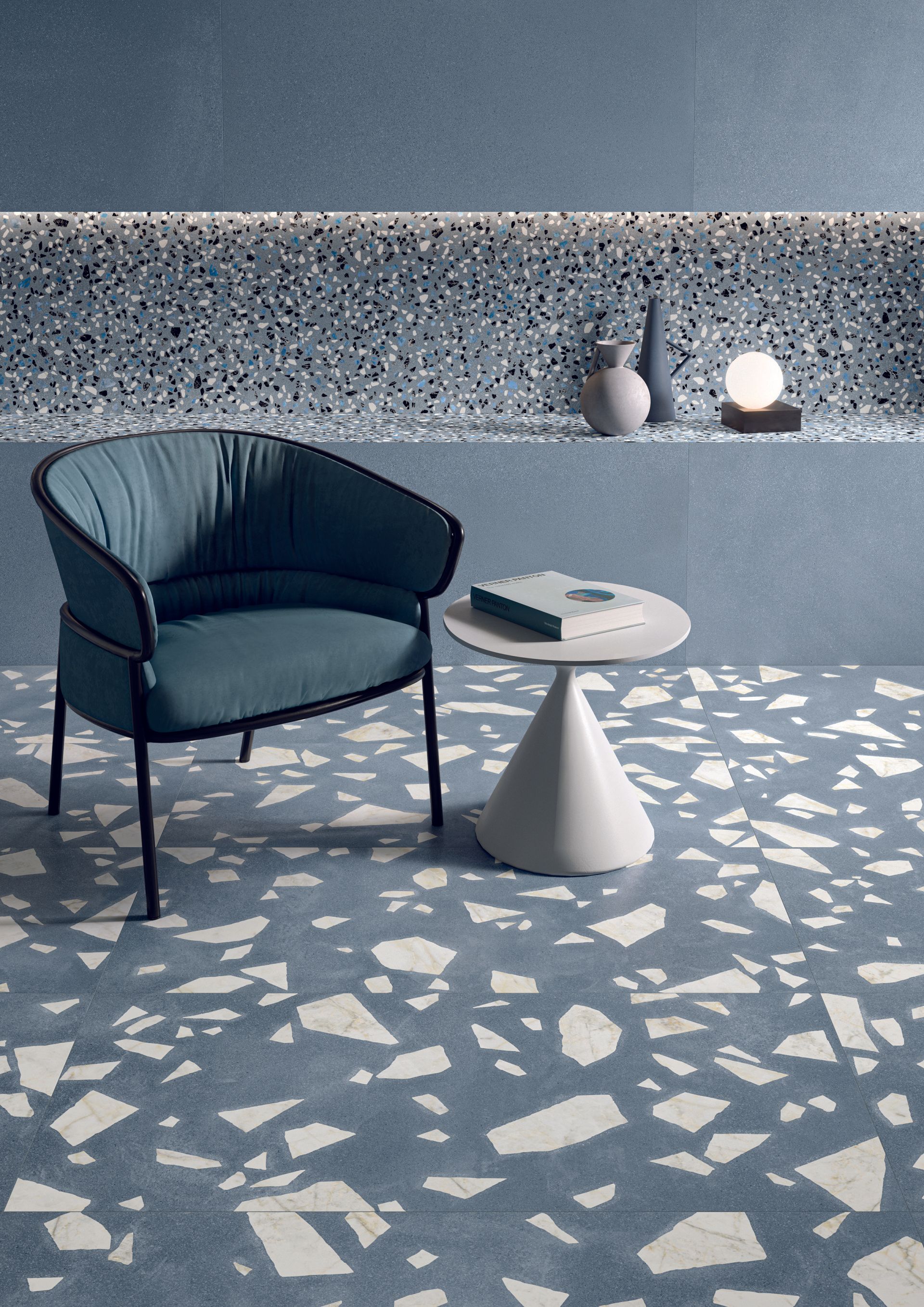terrazzo tiles , blue cushion chair with a white small coffee table ,