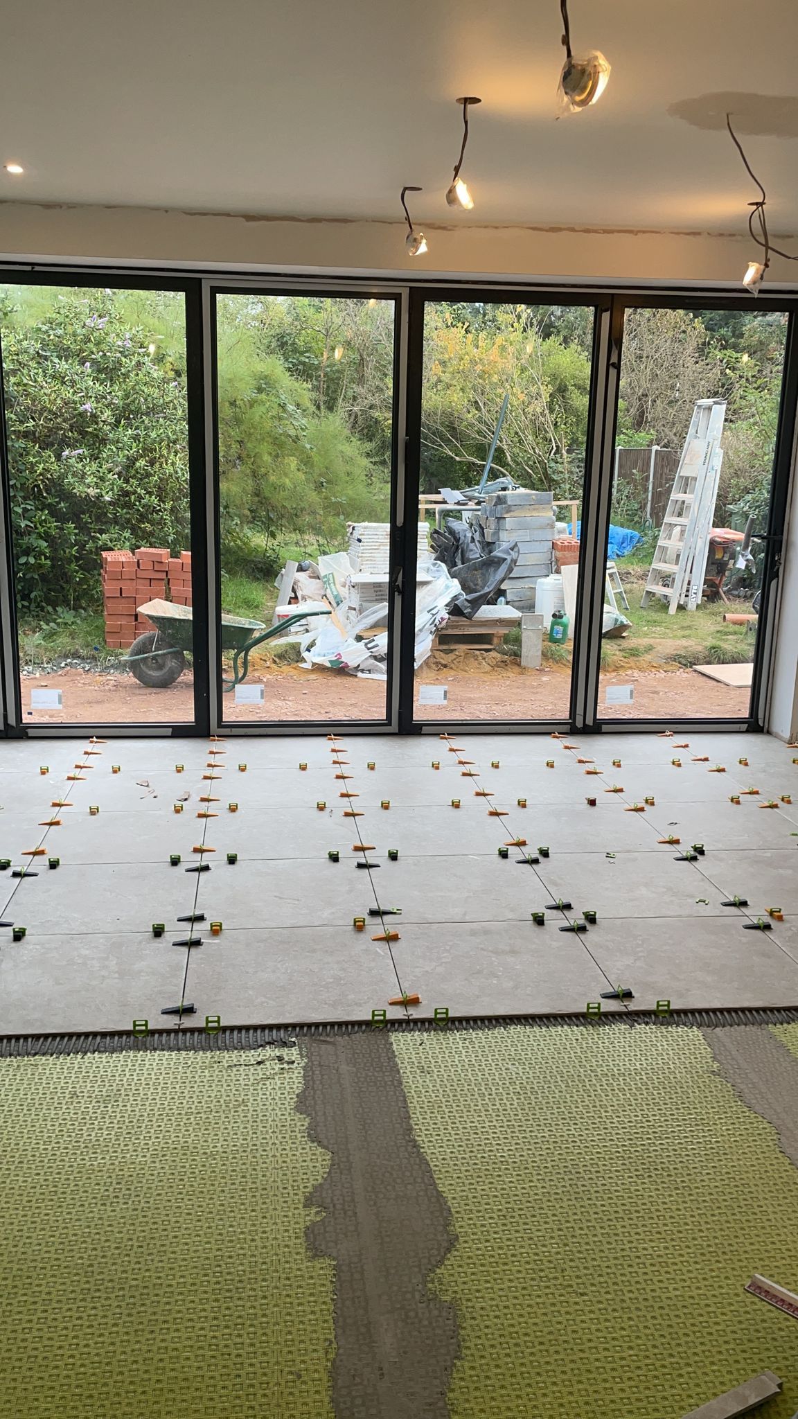 Pierre tumbled effect limestone floor tile, kicthen floor, bifold doors. inside outside flooring. Porcelain floor tile, Dural matting, levelling clips