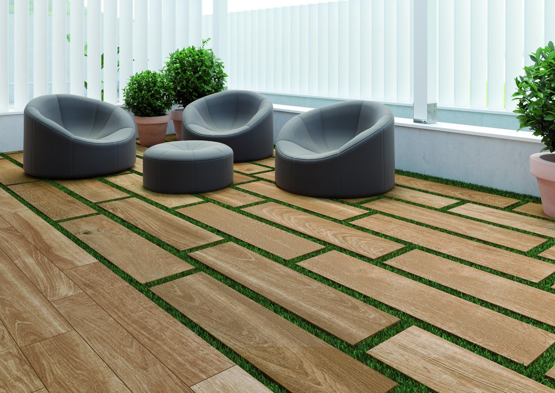 wood patio outside with grass almost like grout lines and grey chairs