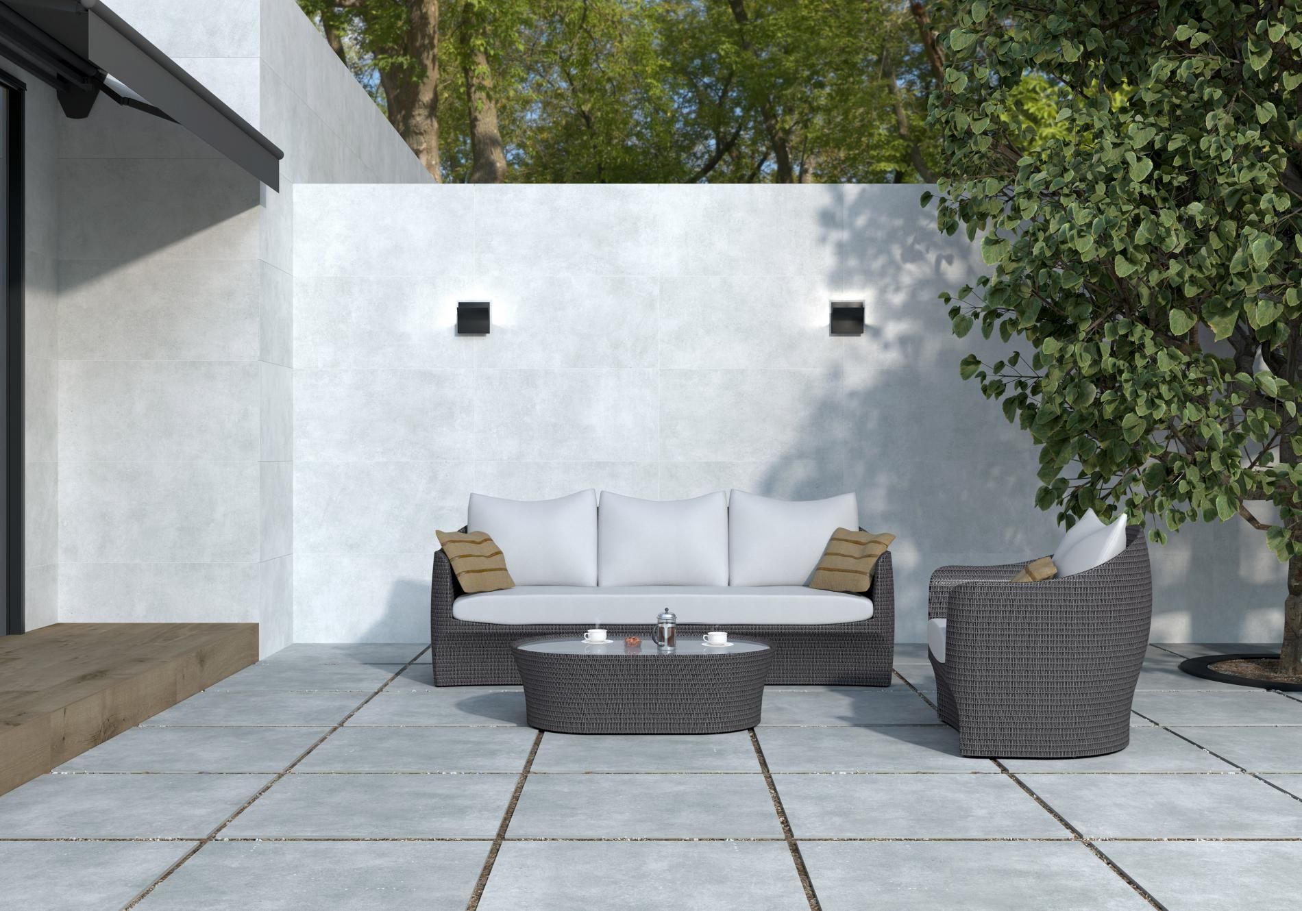 small garden design using indoor and outdoor porcelain paving tiles with a matching coffee table and couch