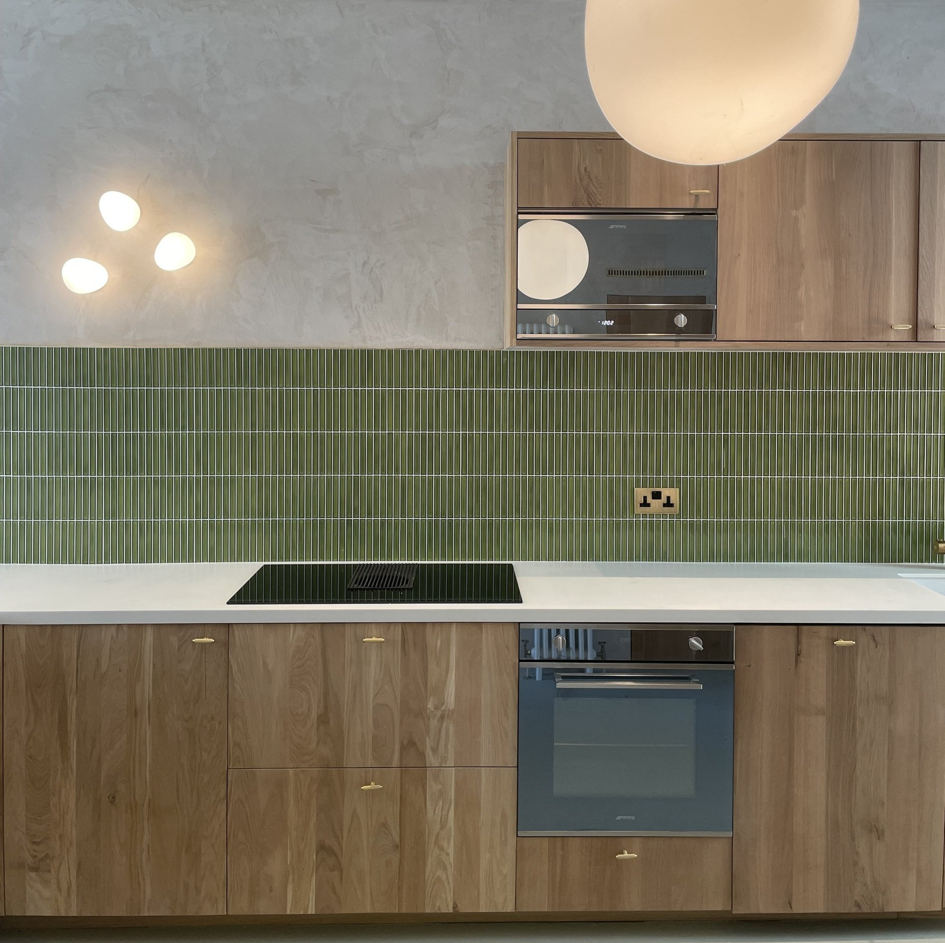 Kit Kat Dark verdi mosaic kitchen splashback, kitchen worktop and copper plug socket