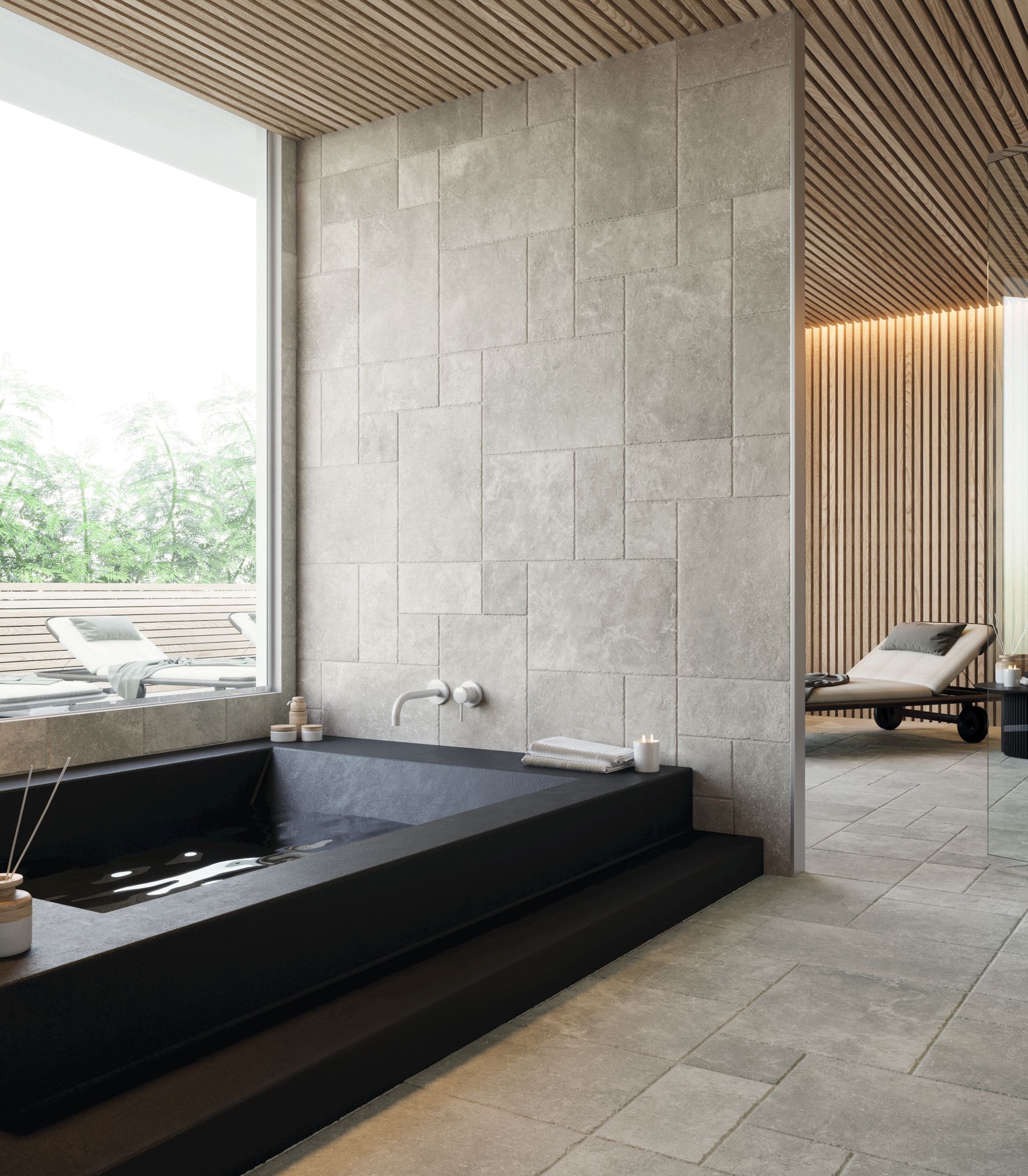 limestone tile used in a spa environment with a scandi aesthetic and a black built in bathtub