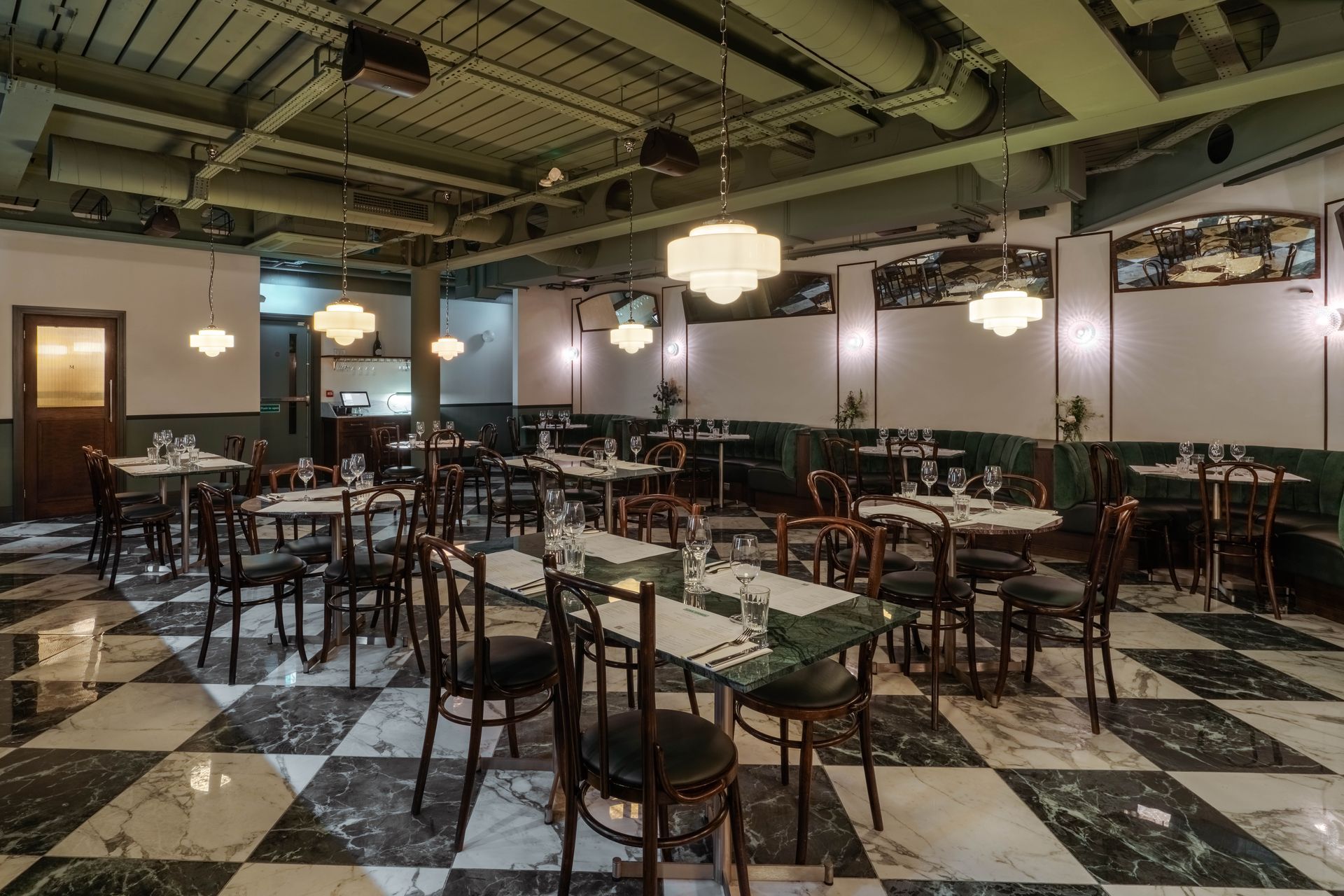 Green and white porcelain marble effect chequerboard floor tile in restaurant floor space.