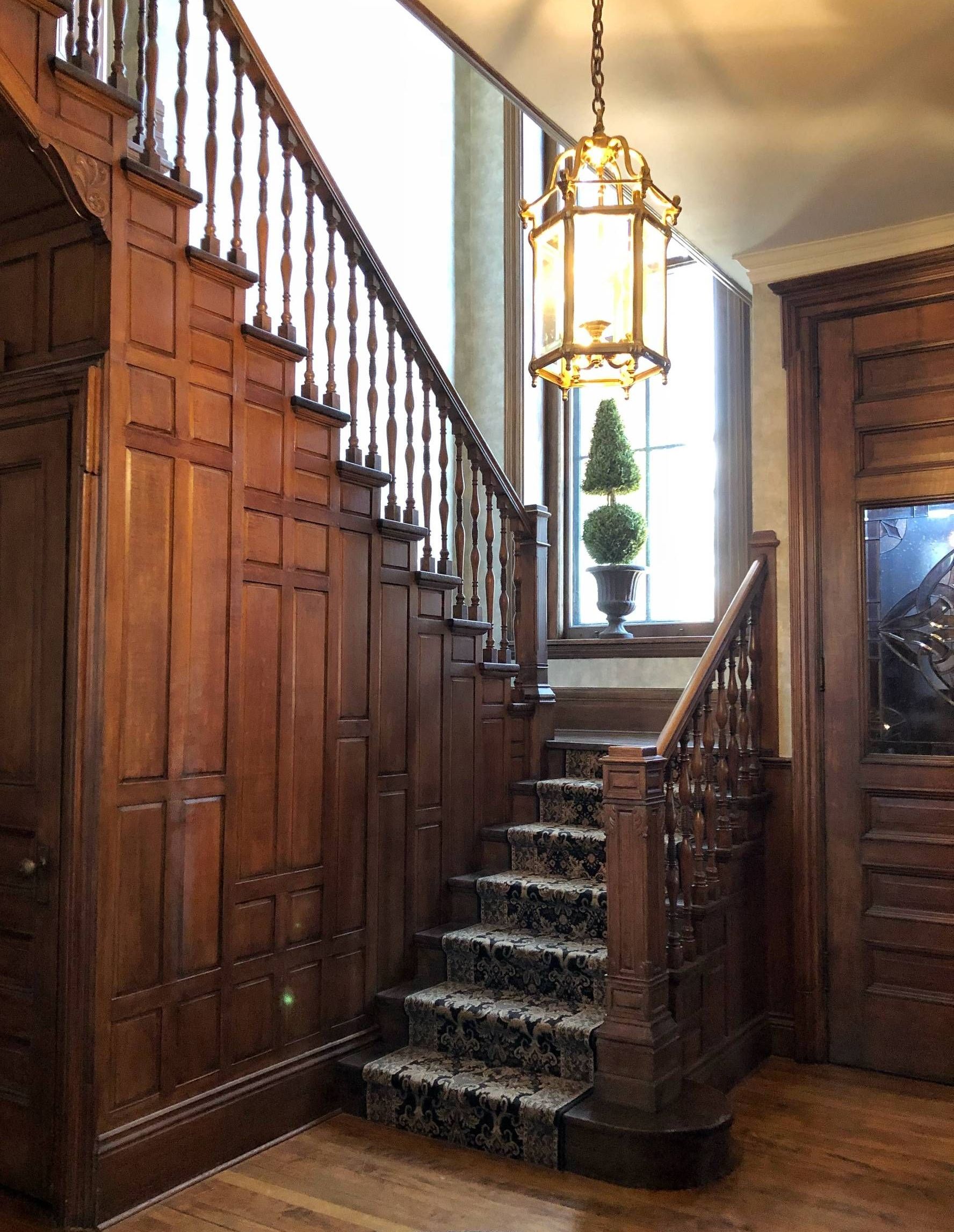 rich wood stair case with colonial decor