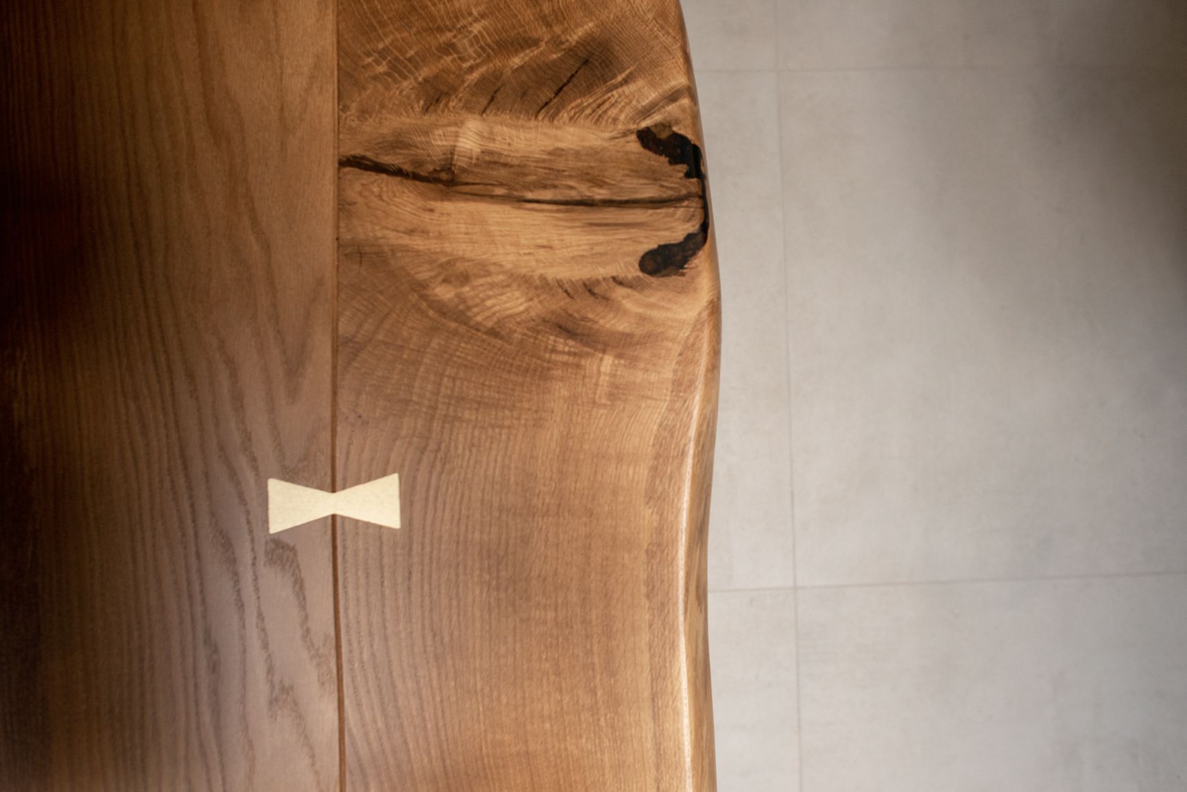 Close up of wood tile next to Grey limestone effect floor tile